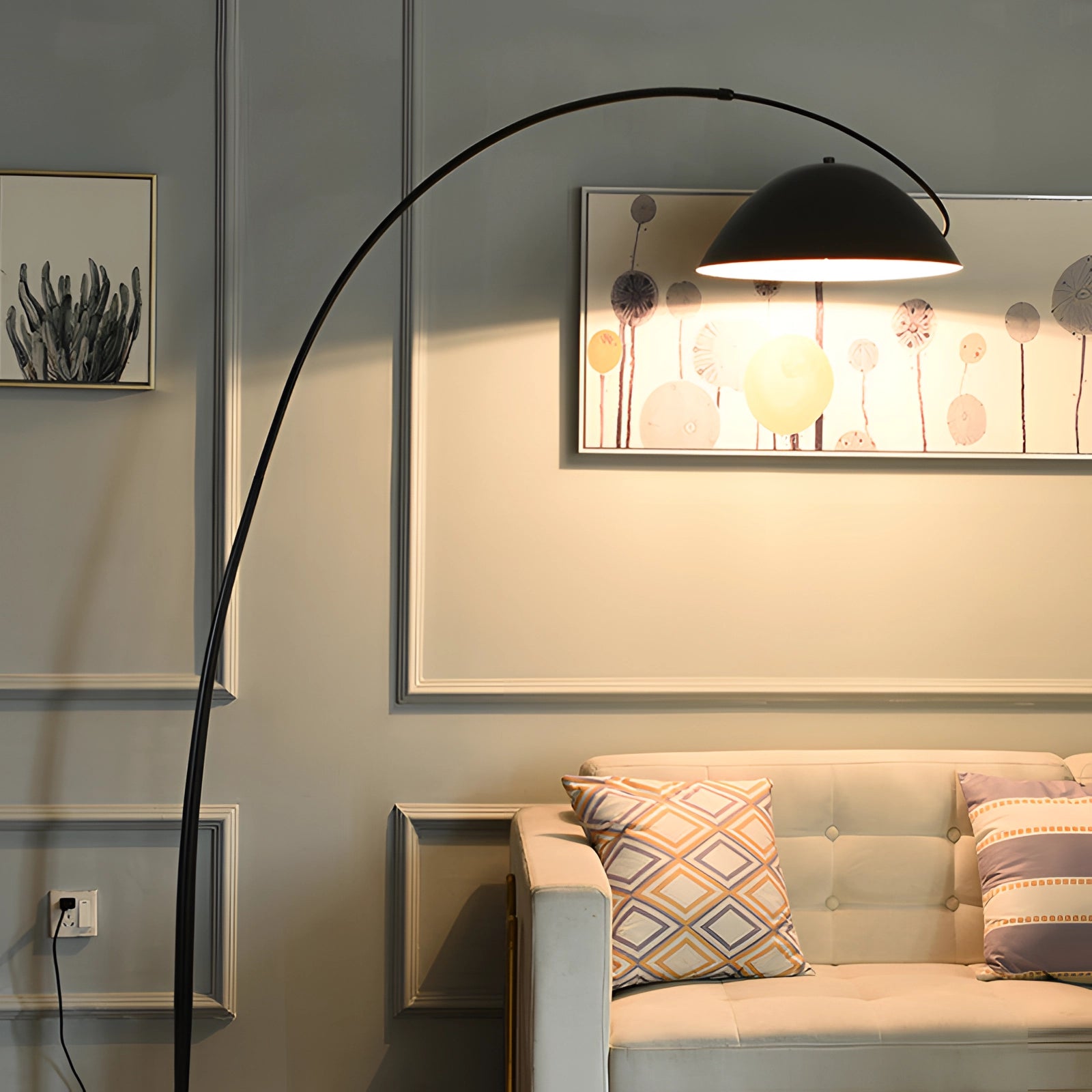 Modern black arched floor lamp with an adjustable dome shade, positioned in a stylish living room setting featuring wooden elements and a comfortable interior design aesthetic.