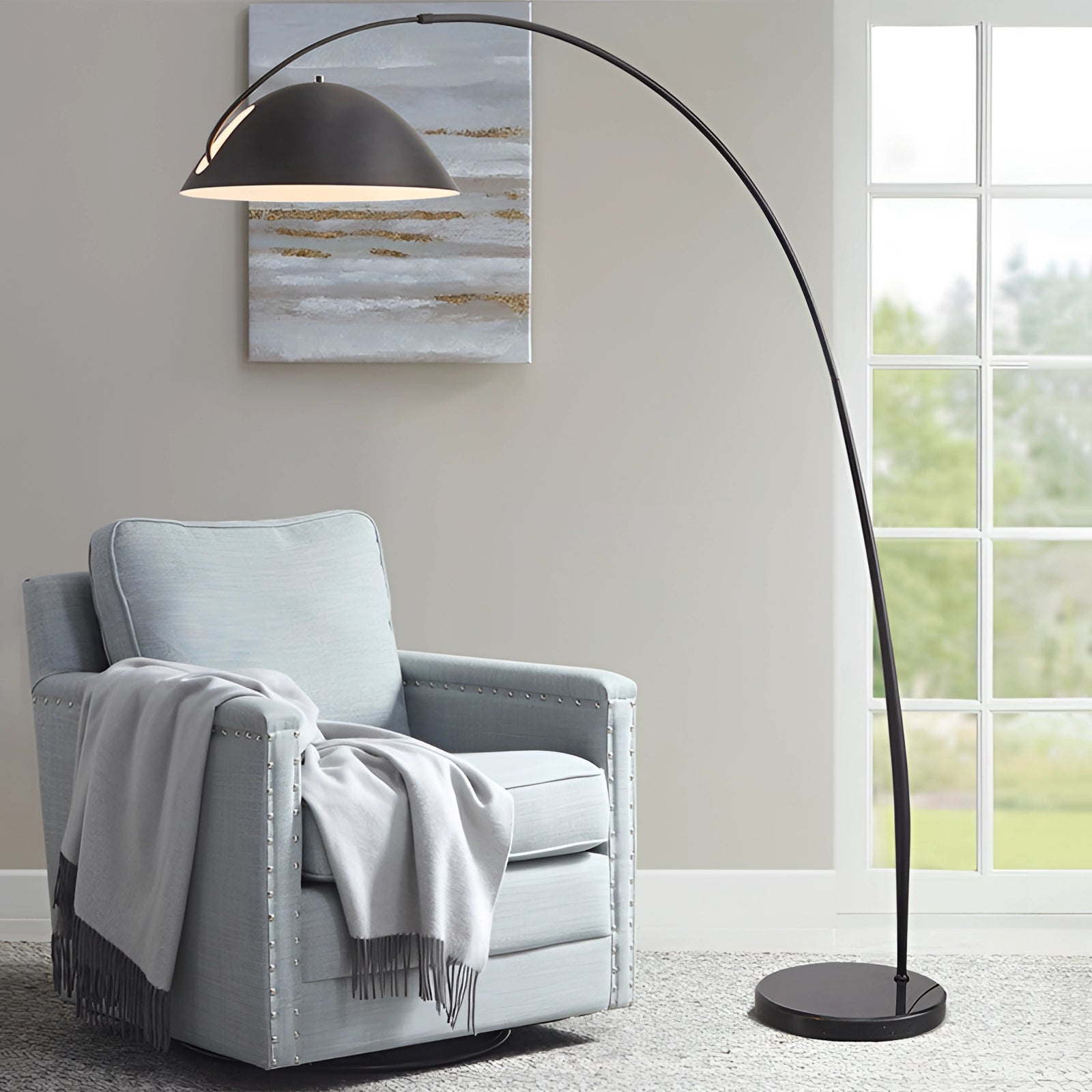 Modern black arched floor lamp with adjustable dome reading light, featuring a sleek design suitable for contemporary interiors, positioned next to a wooden furniture piece in a well-designed living space.