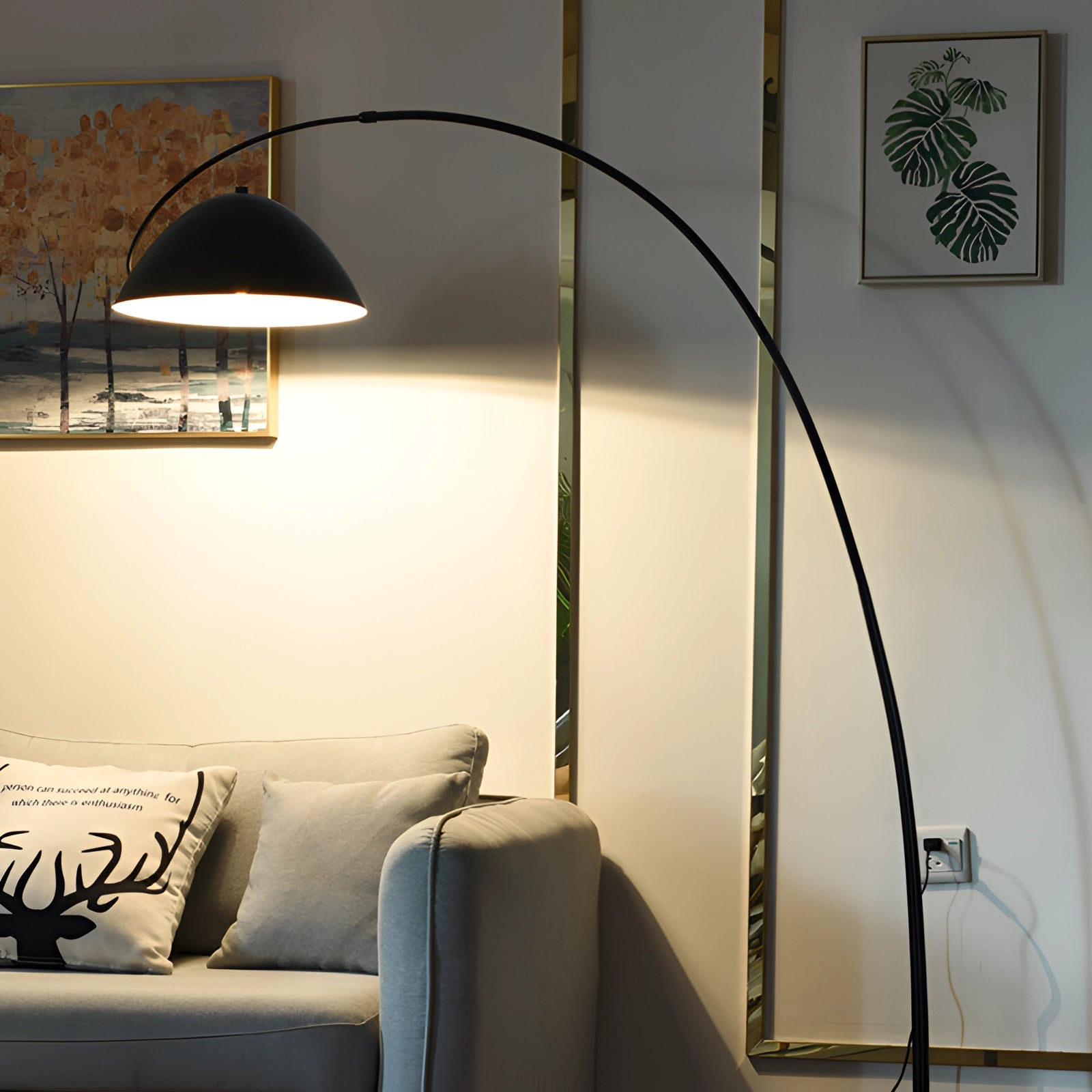 Modern black arched floor lamp with an adjustable dome reading light placed in a stylish living room setting, featuring a comfortable couch and wooden floor, enhancing interior design with its sleek structure and contemporary appeal.