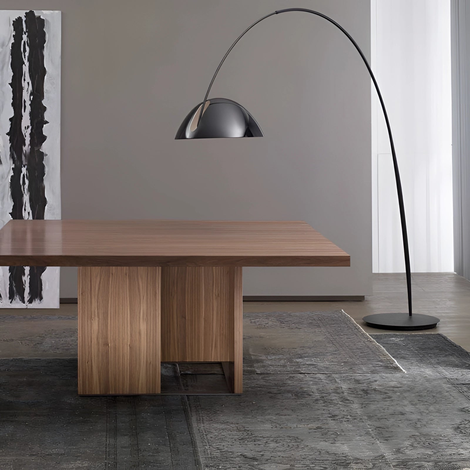 Modern black arched floor lamp with an adjustable dome light, placed in a stylish interior setting showcasing wooden flooring and contemporary furniture.