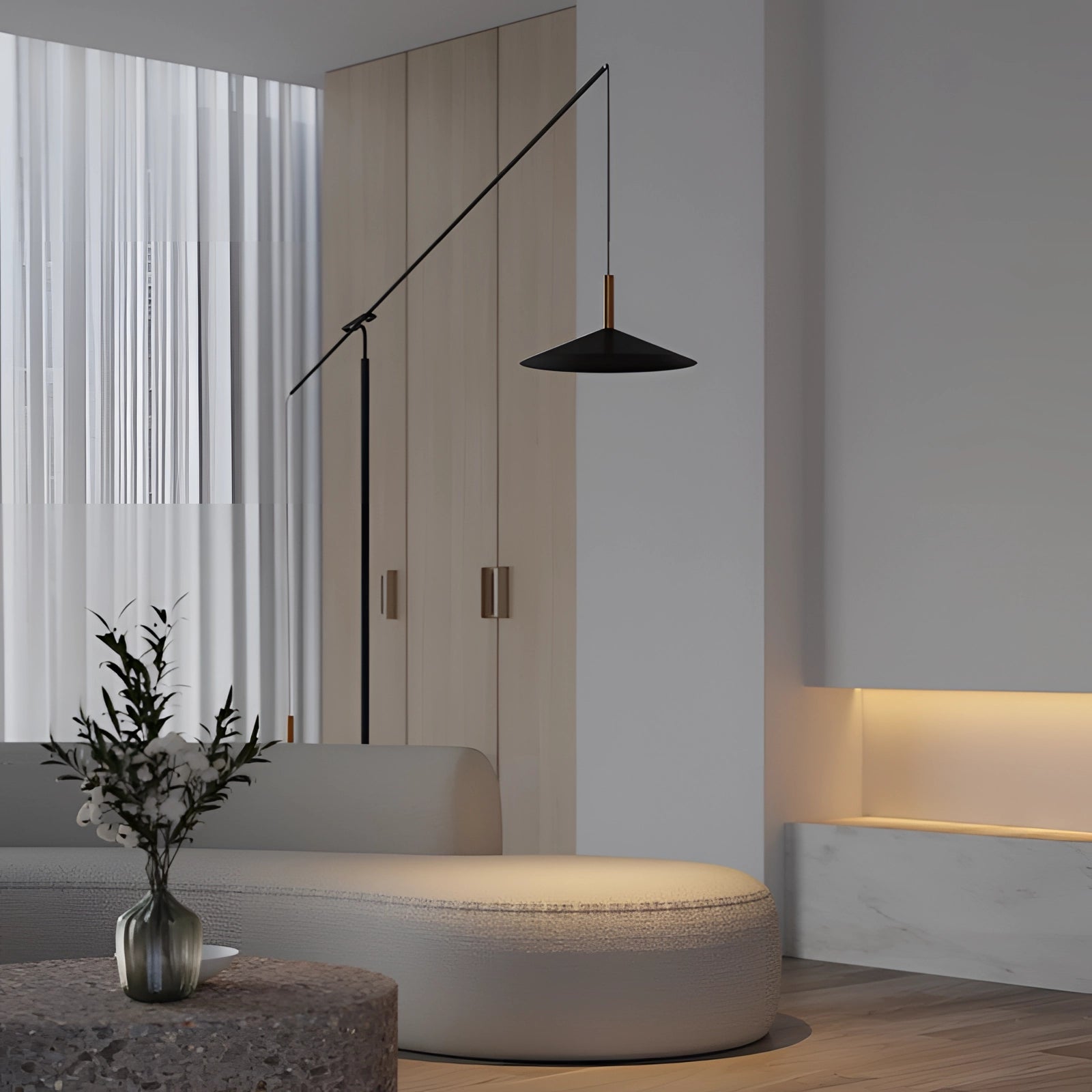 Modern black and gold adjustable designer floor lamp in a stylish living room setting with a comfortable couch, wooden elements, and a decorative plant.