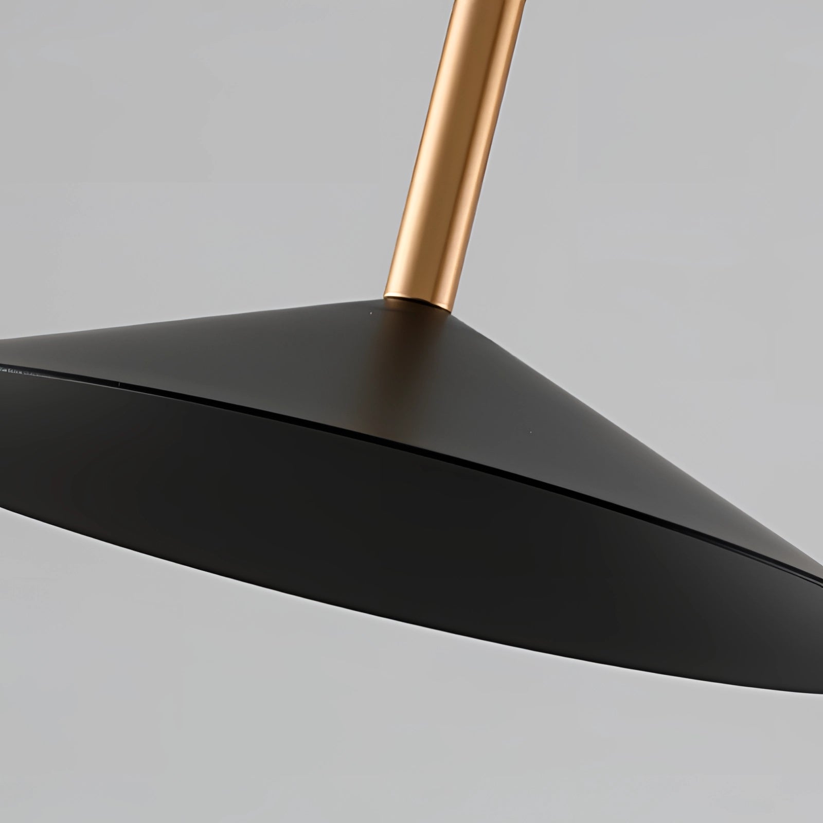 Modern black and gold adjustable designer floor lamp with a sleek, minimalist design featuring metal and aluminum components, a balanced rectangular base, and a conical lampshade.