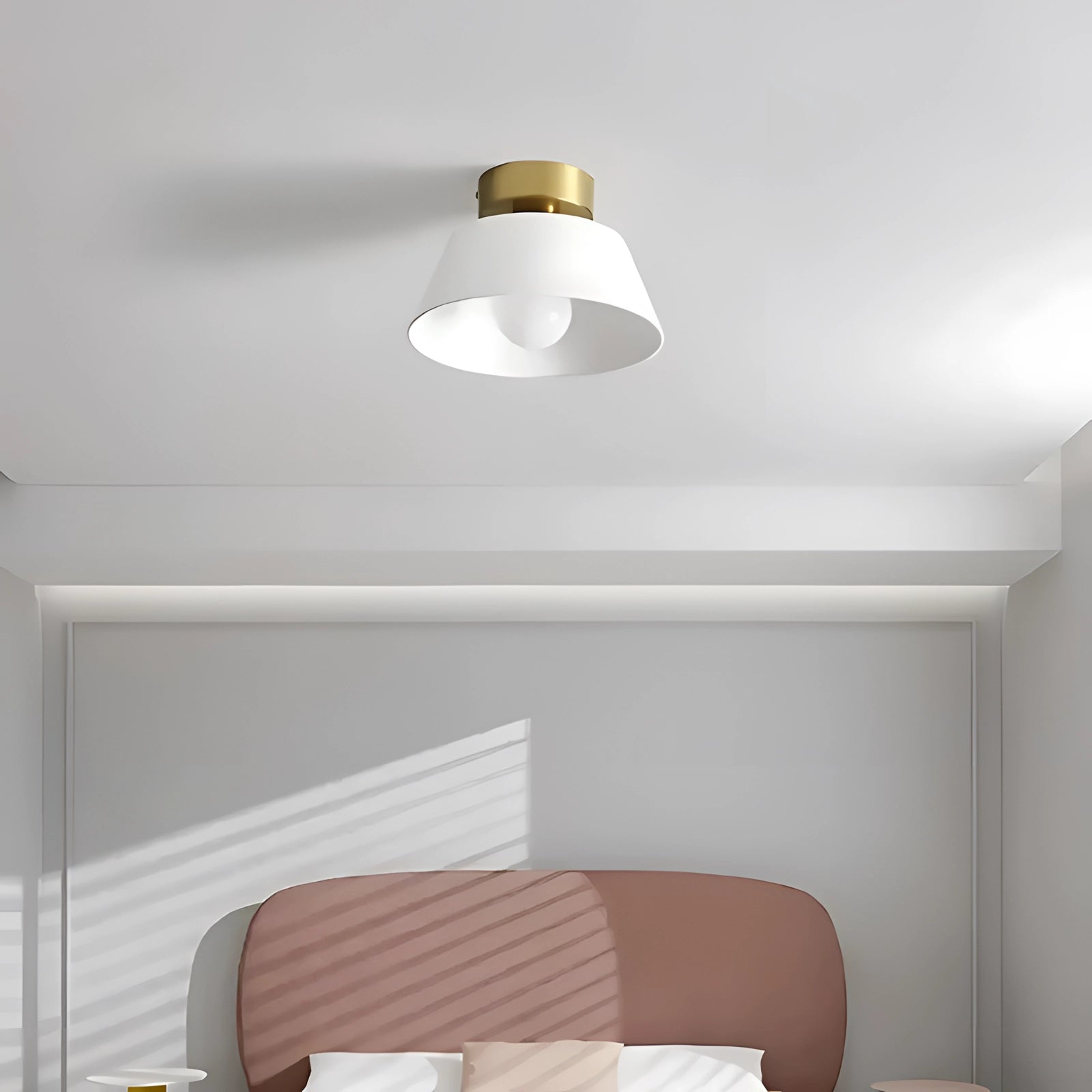 Modern white and gold LED ceiling lamp with a minimalist design, featuring a sleek pendant light hanging from a ceiling in a contemporary interior setting with neutral tones and wooden accents.