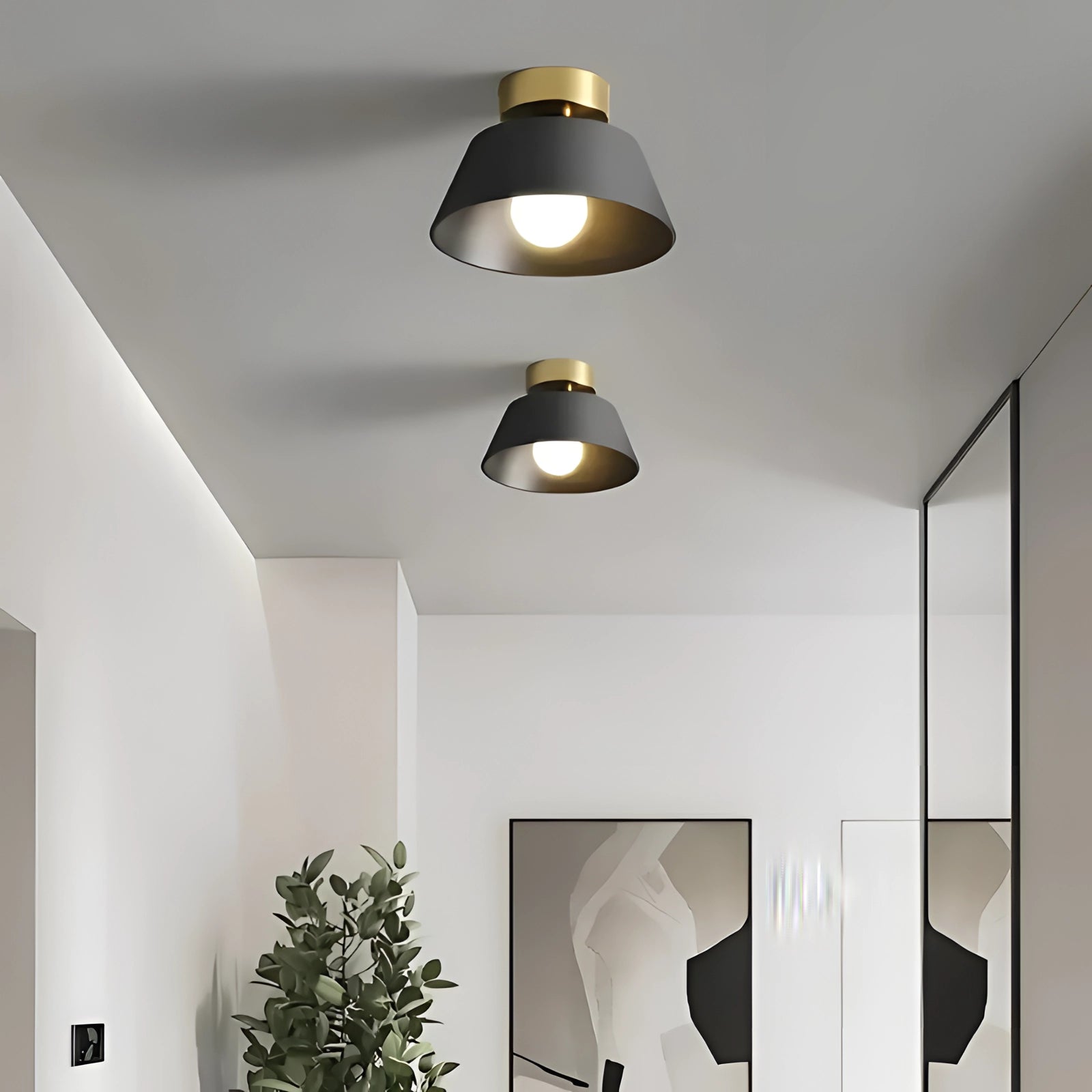 Modern black and gold LED ceiling lamp with a minimalist design, hanging as a pendant light in a stylish interior setting featuring wooden elements, houseplants, and sleek architectural lines.