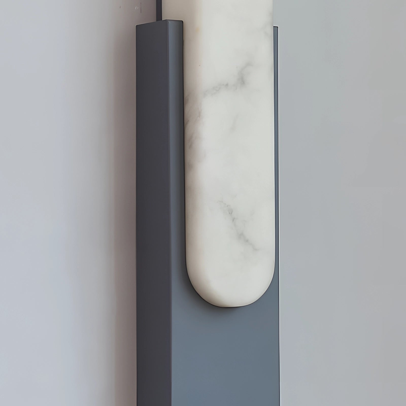 Modern black and gold LED wall sconce featuring a minimalist design, mounted indoors, highlighting a sleek metal and glass construction with rectangular elements.