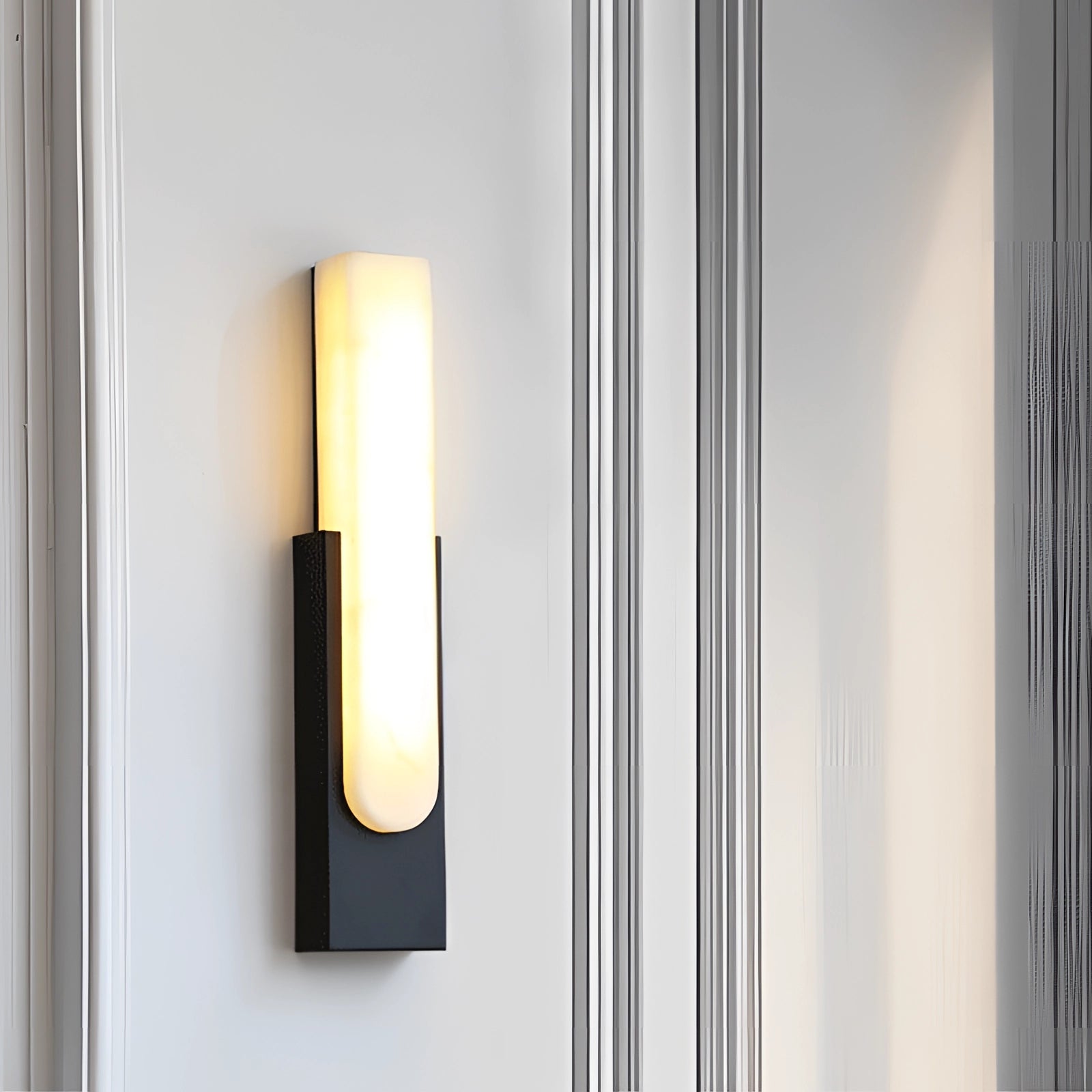 Modern black and gold LED wall sconce with a minimalist design featuring a rectangular shape, a combination of metal and glass materials, ideal for indoor lighting.