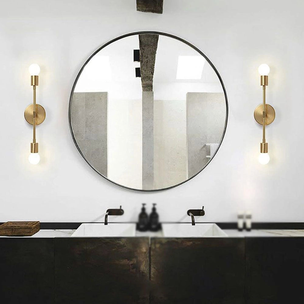 Modern black and gold minimalist wall sconce featuring an Edison bulb, mounted on a wooden wall, illuminating a space with elegant lighting.