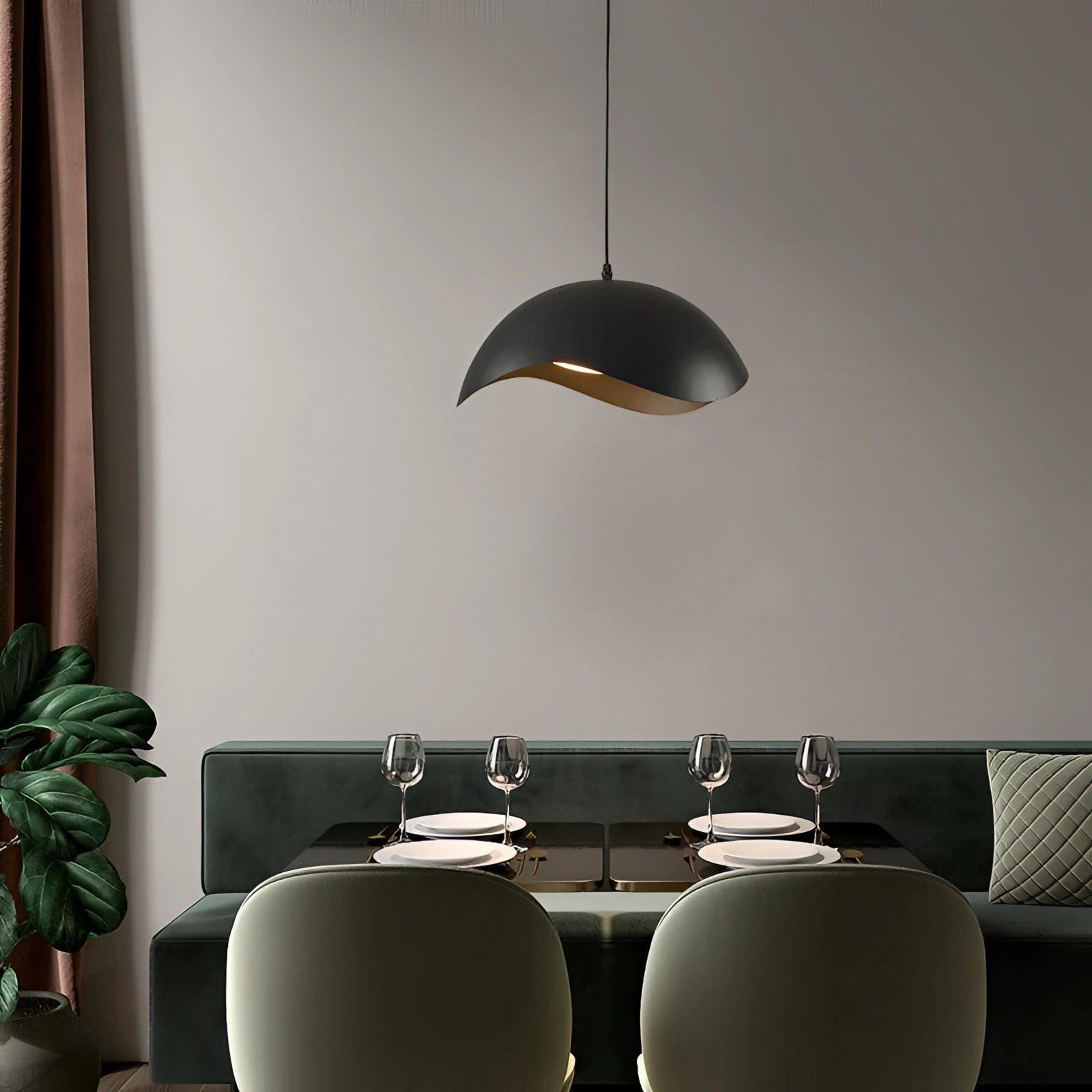 Modern black and gold pendant lights hanging from the ceiling, illuminating a chic dining area adorned with houseplants and a wooden table.