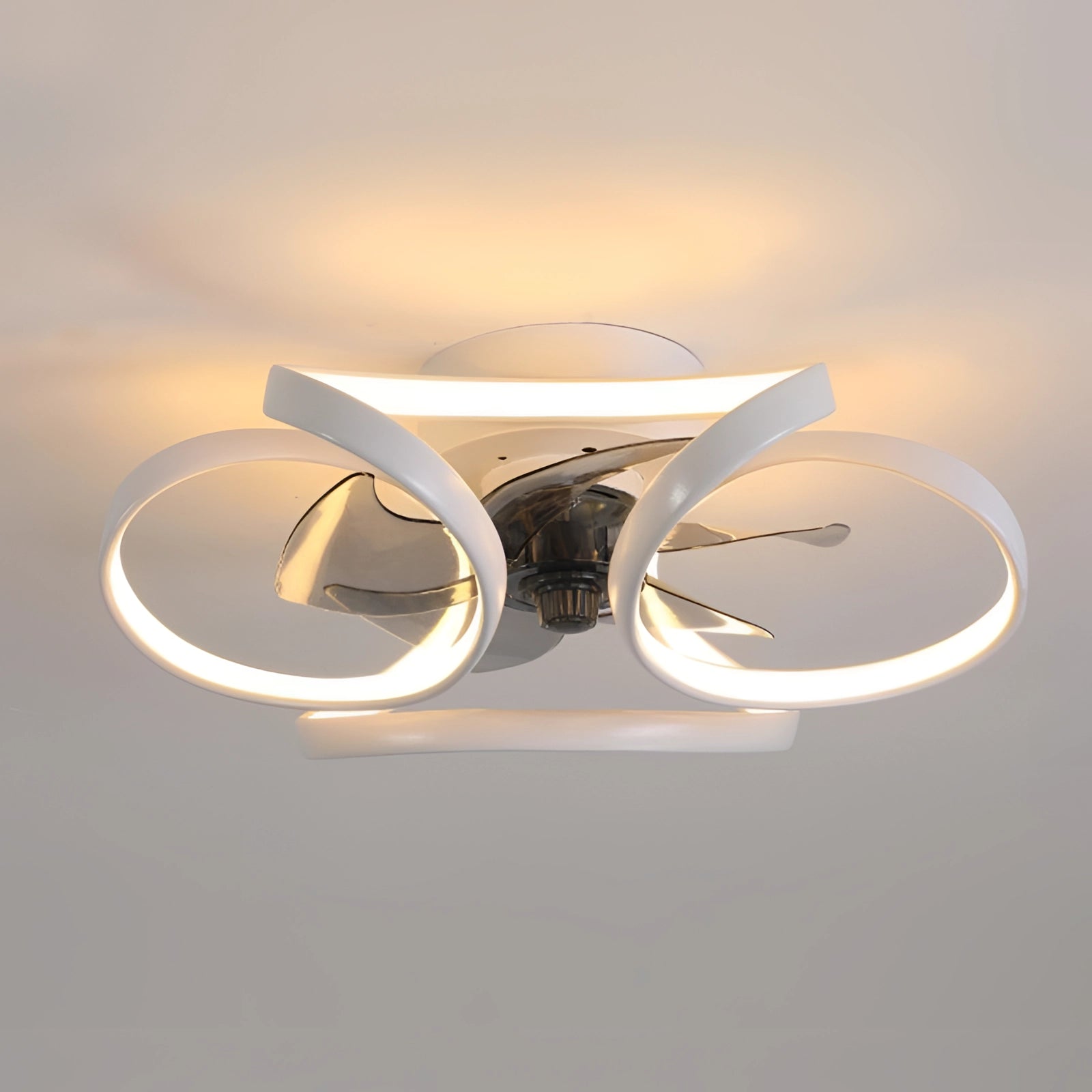 Modern black LED ceiling fan with light and remote installed in a bedroom.
