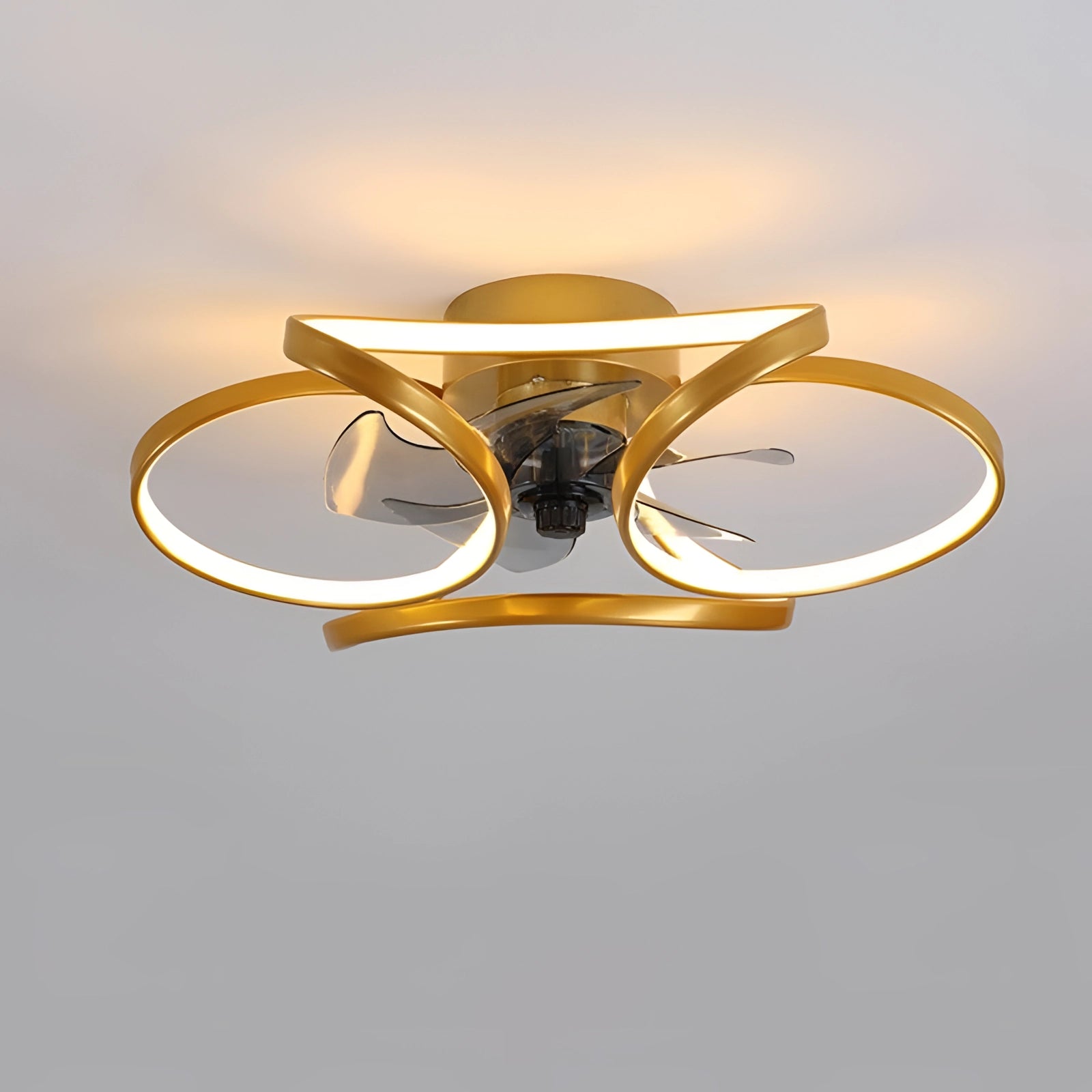 Modern black LED ceiling fan with light and remote, installed in a bedroom, featuring a sleek and contemporary design with metallic accents.