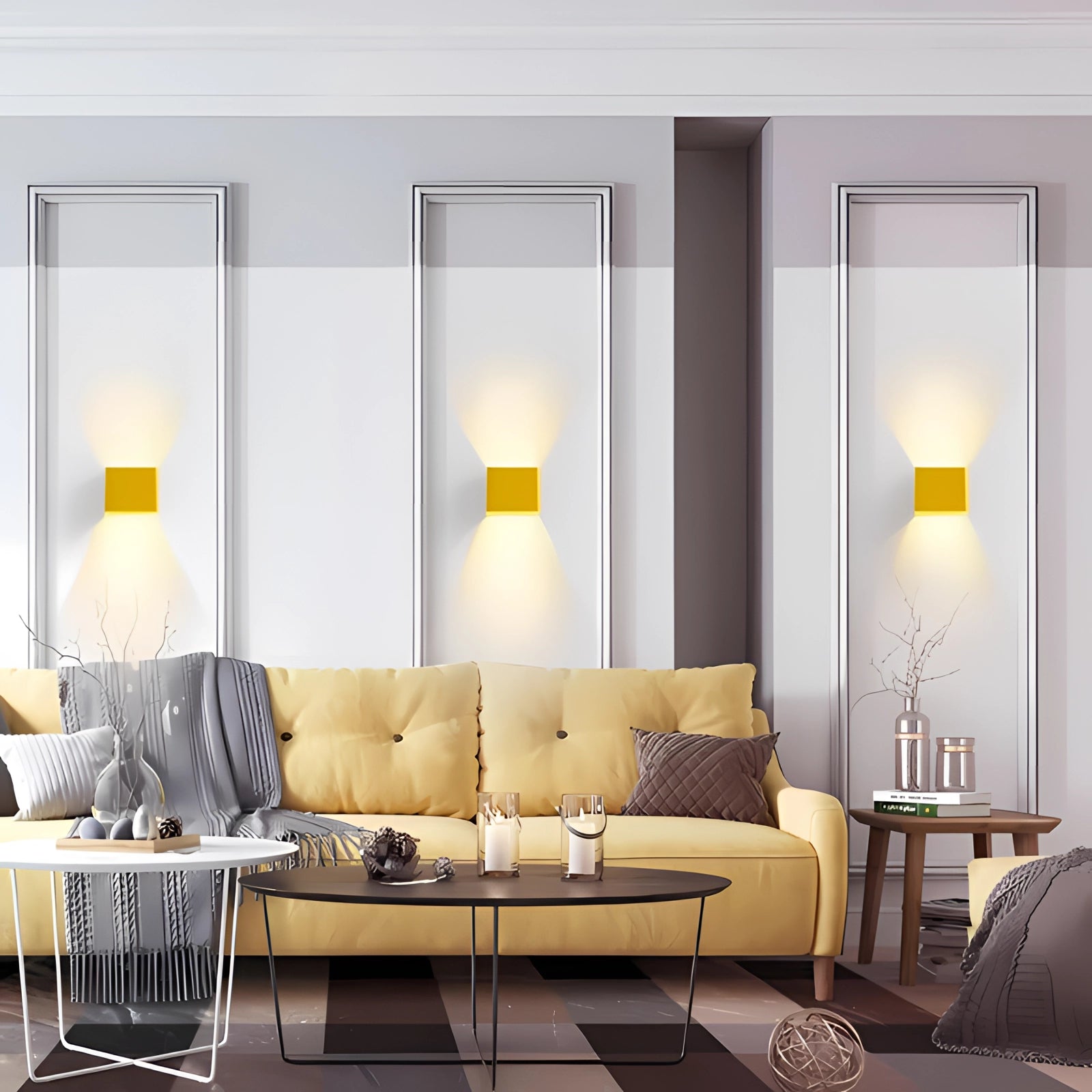 Modern black LED wall sconce with a geometric design mounted on a grey wall, illuminating a stylish interior space with contemporary decor elements including a couch and table.