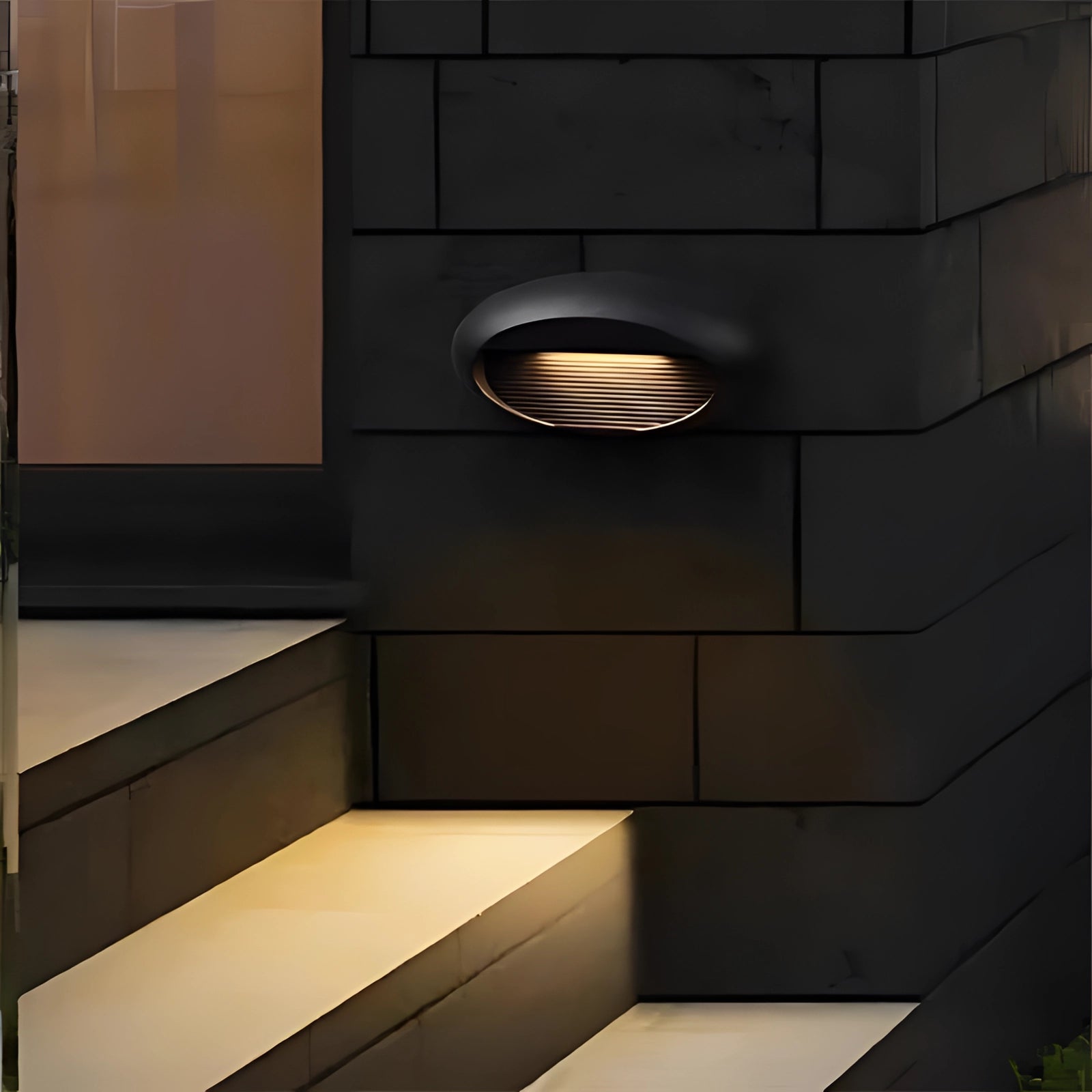 
A modern black LED wall sconce with a sleek rectangular design, mounted outdoors on a wooden surface, showcasing its stylish and durable waterproof construction.