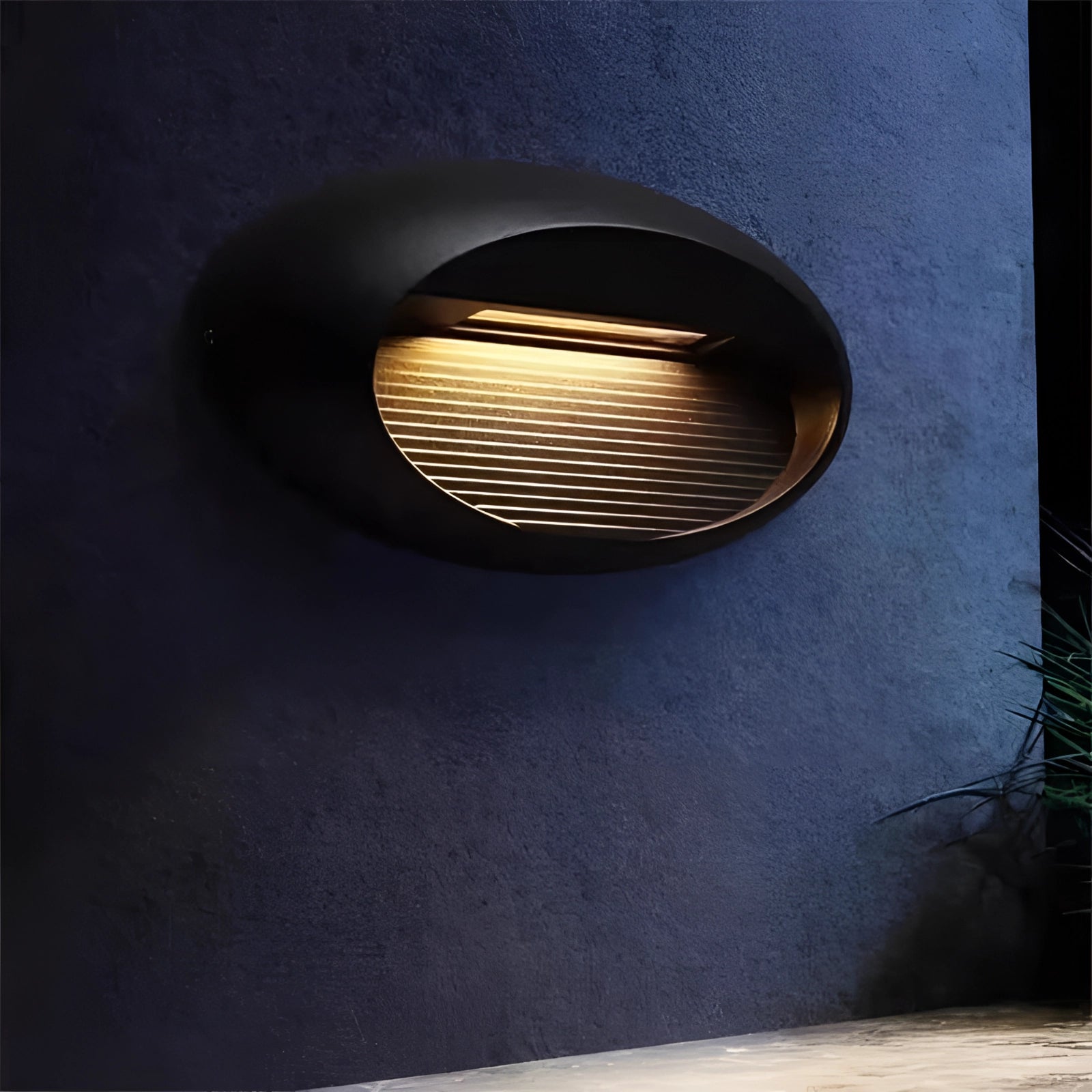 Modern black LED wall sconce with a rectangular shape and sleek design, mounted on a wooden surface. The sconce is suitable for outdoor use, featuring waterproof and durable materials.