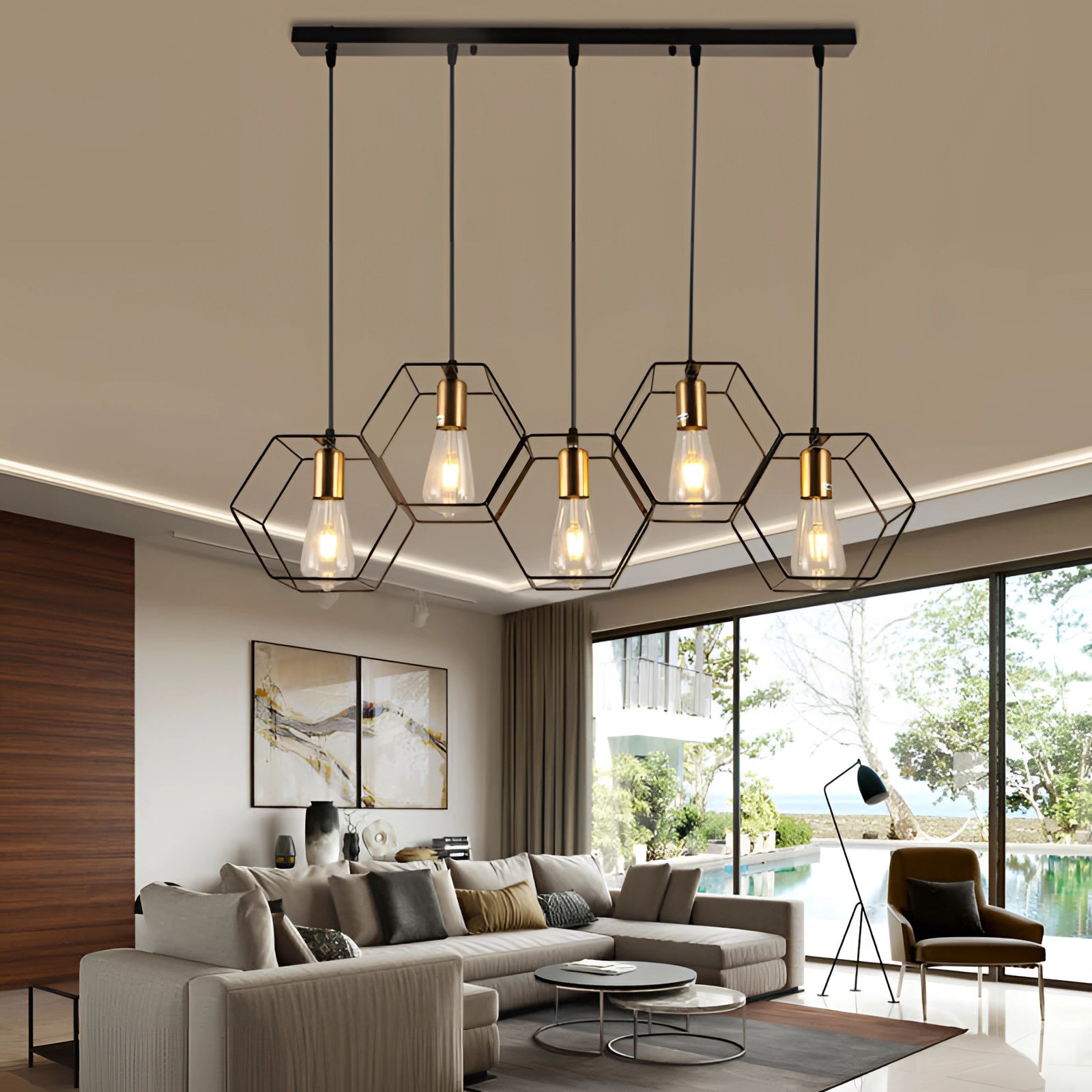 Modern black metal geometric five-light pendant chandelier hanging in a stylish living room with contemporary furniture, including a couch and table, near a window and picture frame.