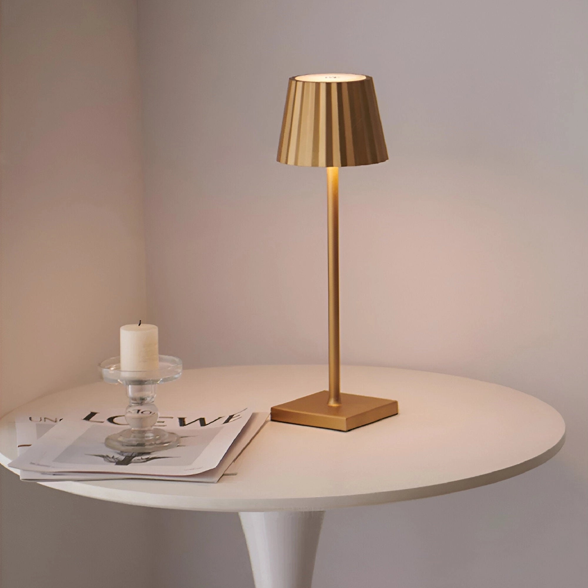 Modern black minimalist LED table lamp with a sleek and elegant design featuring gold accents, a smooth wooden base, and a simple cylindrical lampshade.