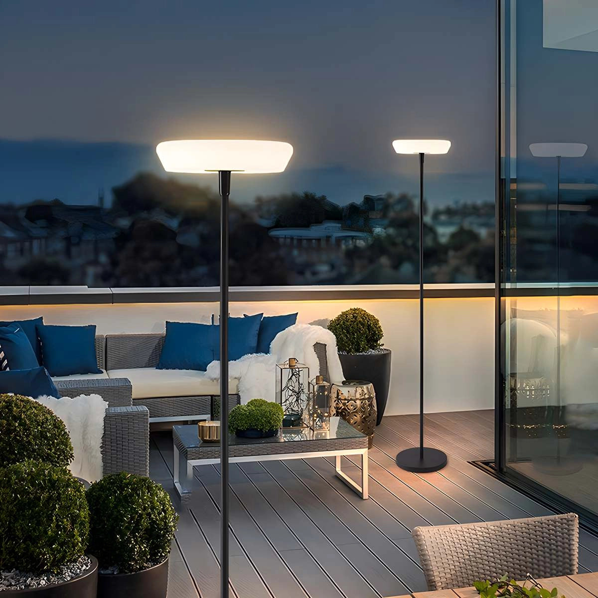 Modern black minimalist LED torchiere floor lamp with slim design, placed near a plant in a well-lit room.