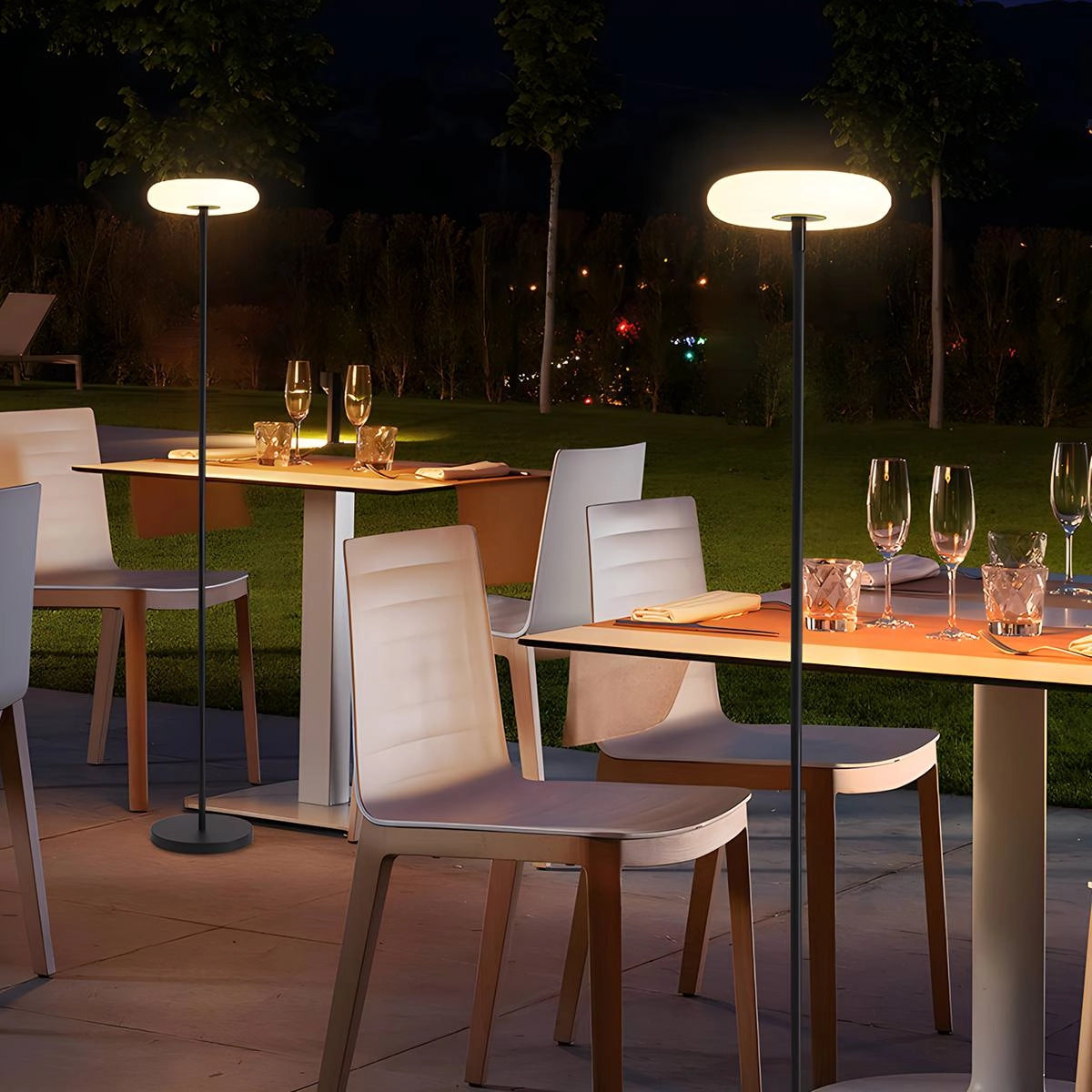 Modern black minimalist LED torchiere floor lamp with slim design, standing in a contemporary indoor setting.