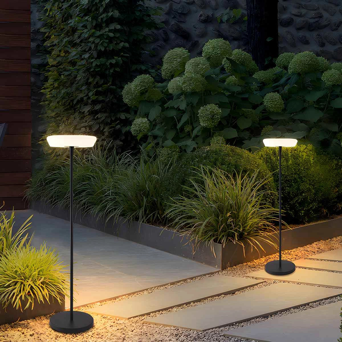 Modern black minimalist LED torchiere floor lamp, slim and energy-efficient, placed in a stylish room with green plants and a natural landscape visible through the windows.