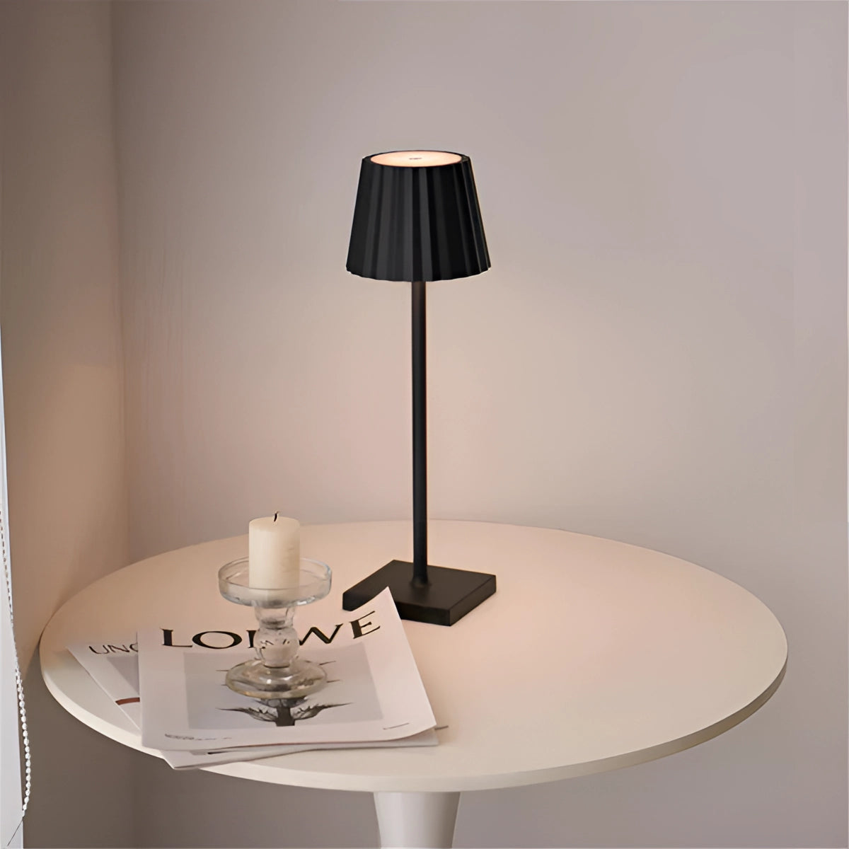 Modern black minimalist table lamp with a slim profile elegantly placed on a wooden surface, showcasing its sleek design and subtle lighting, enhancing the interior decor.