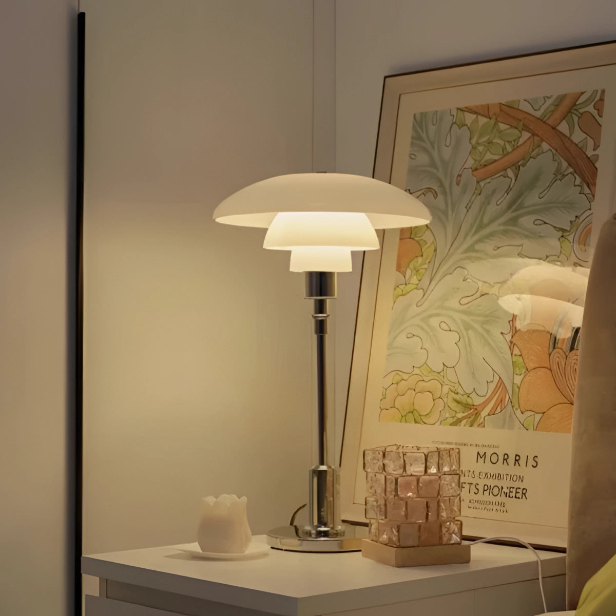 Modern black mushroom shade table lamp with adjustable height and frosted glass, placed on a wooden table in a stylish interior setting.