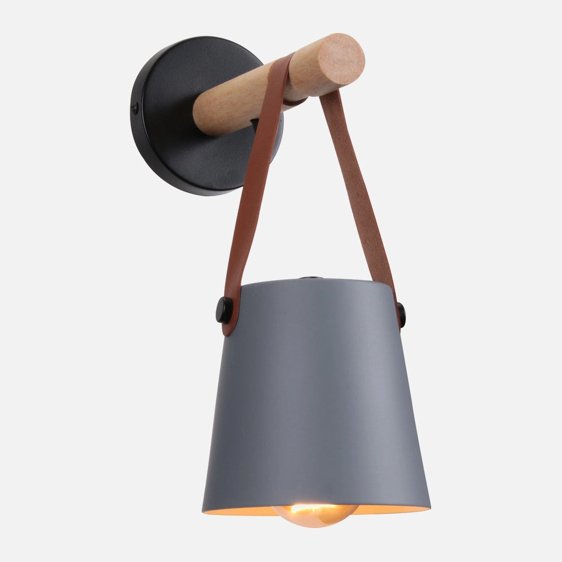 Modern black wall sconce with grey shade, leather strap, and wood accent, mounted on a wall.