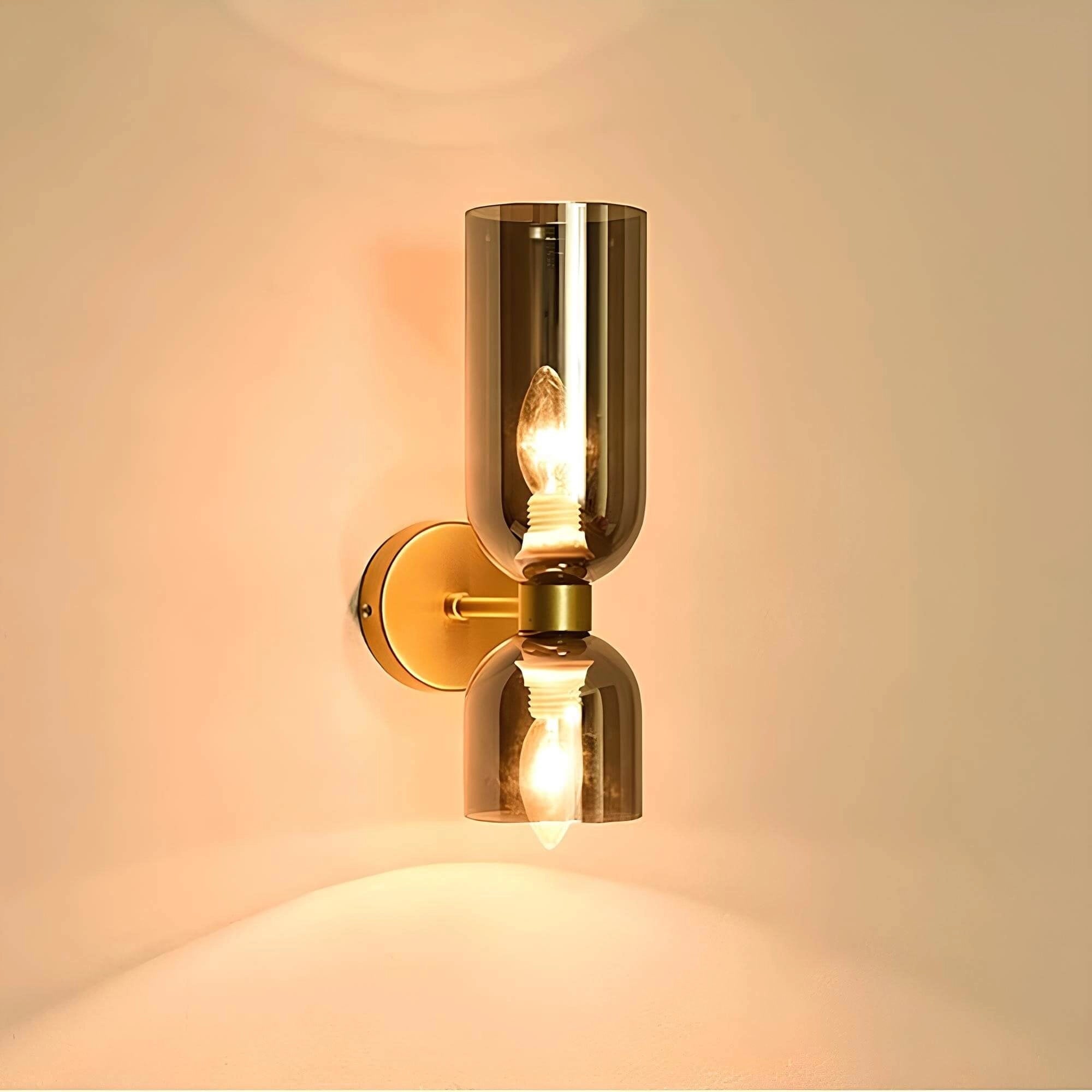 Modern blue glass wall sconce with a brass accent, featuring a rectangular design that combines sleek metal and tinted glass elements for luxury lighting.