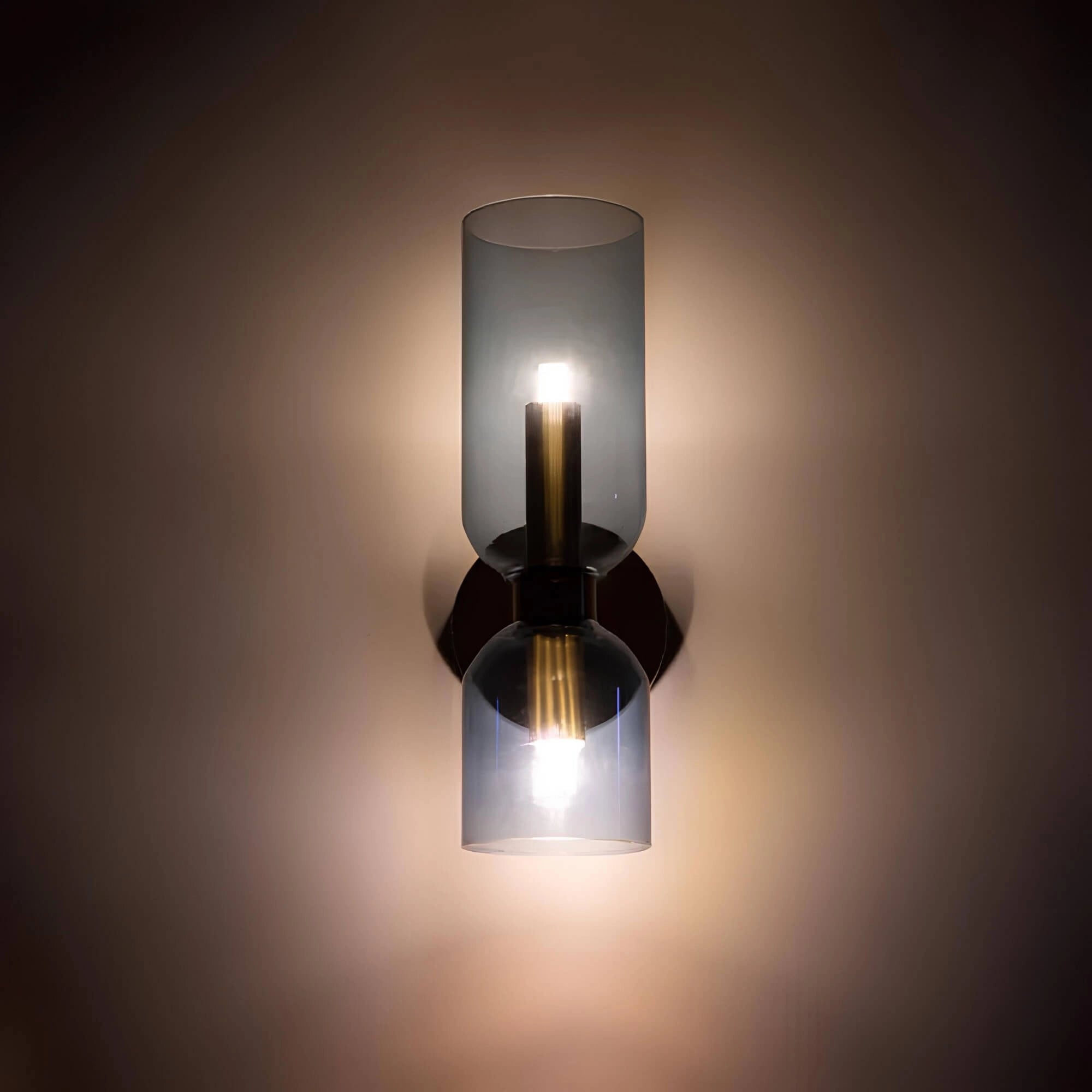 Modern blue glass wall sconce with a brass accent, designed as luxury lighting, featuring a sleek and artistic style with a prominent light bulb, illuminating with a soft, ambient glow.