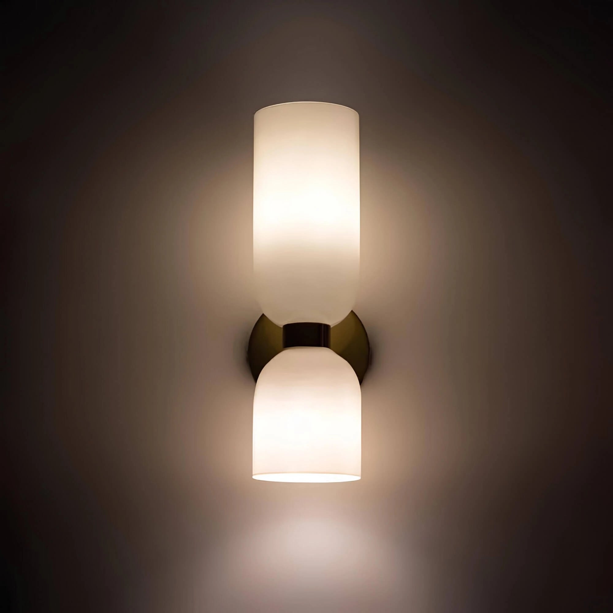 Luxurious modern blue glass wall sconce with a brass accent, featuring a sleek circular design and sophisticated lampshade, suitable for artistic and elegant home lighting.