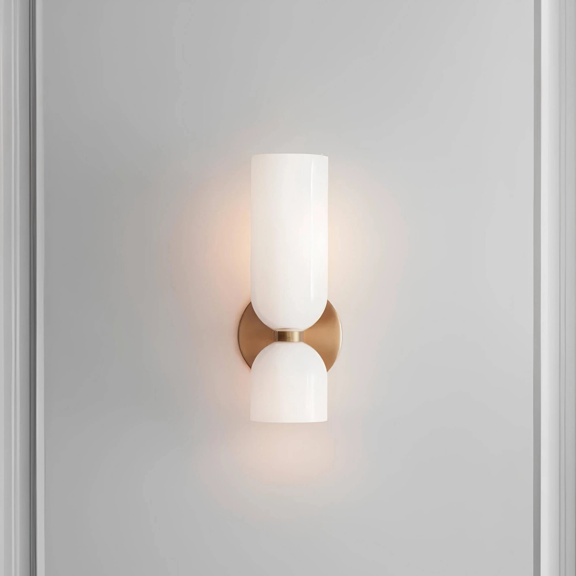 A modern blue glass wall sconce with a brass accent, featuring a cylindrical shape and mounted on a wooden base. The sconce emits a soft white fluorescent light, adding a touch of luxury to any space.
