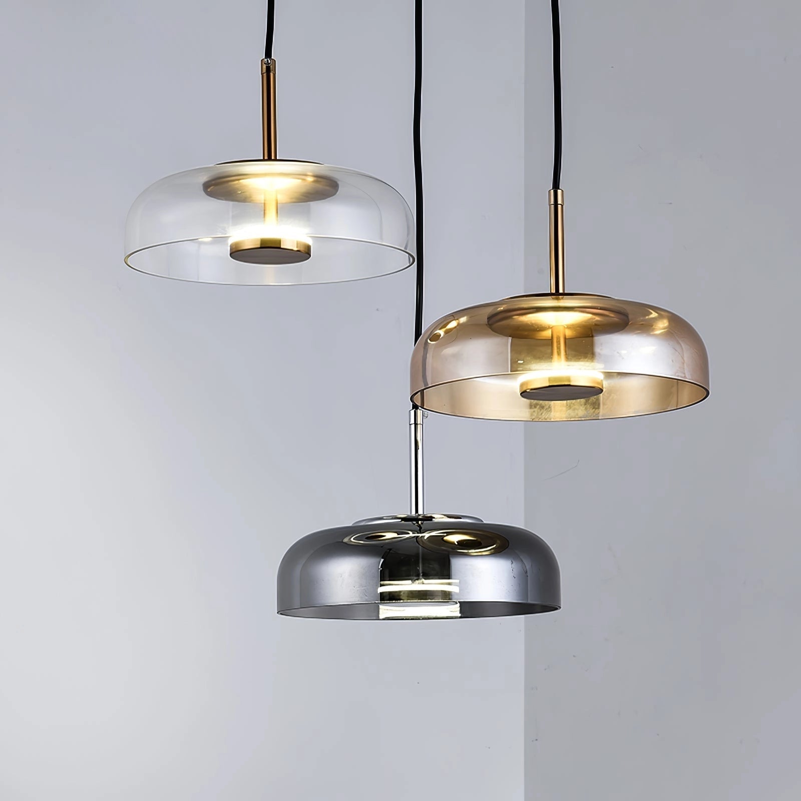 Modern Brass and Chrome LED pendant lights with a luxury minimalist design, featuring glass and metal ceiling fixtures.