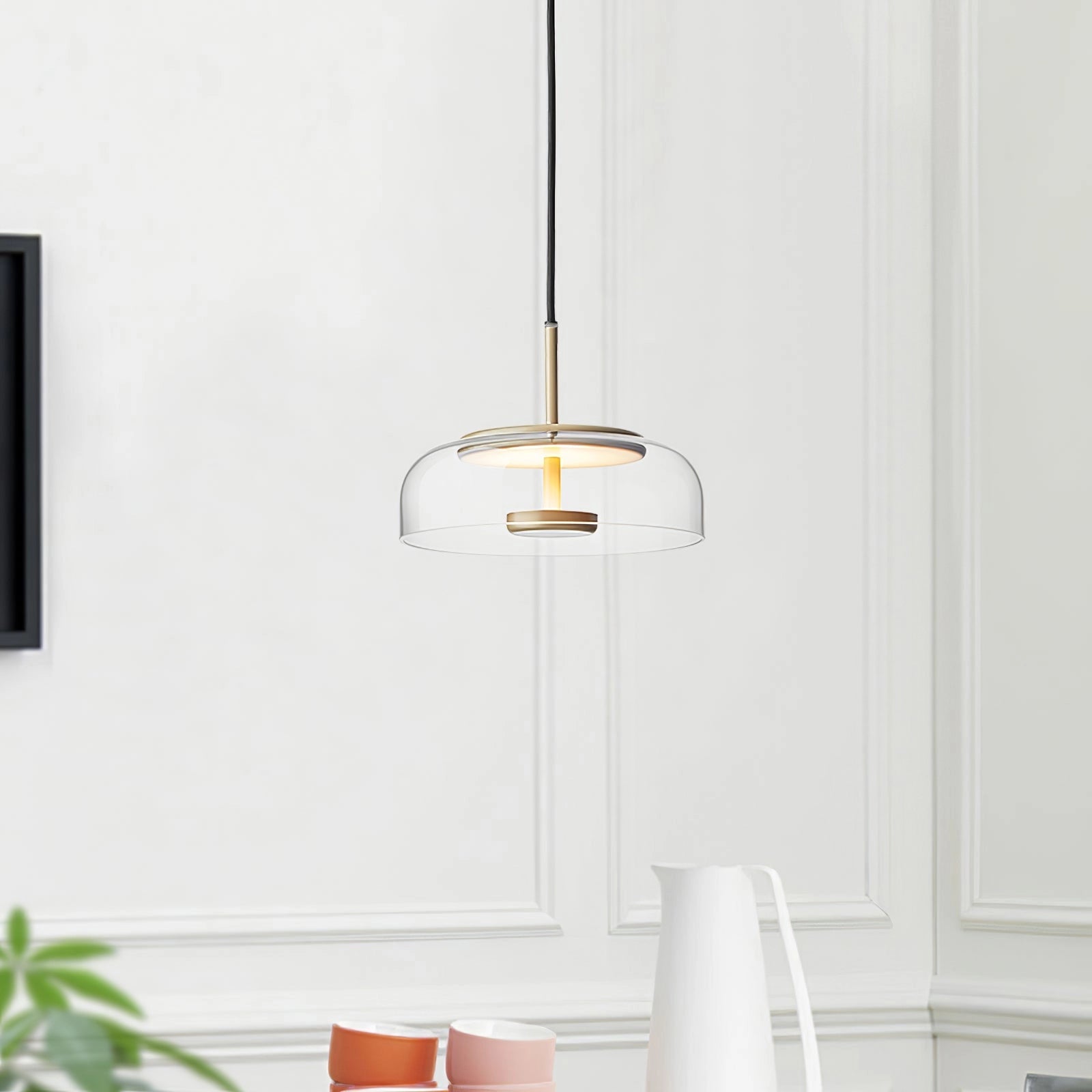 Modern brass and chrome LED pendant lights with a minimalist design, hanging from the ceiling in a contemporary interior setting, featuring a rectangular shape and sleek finishes.