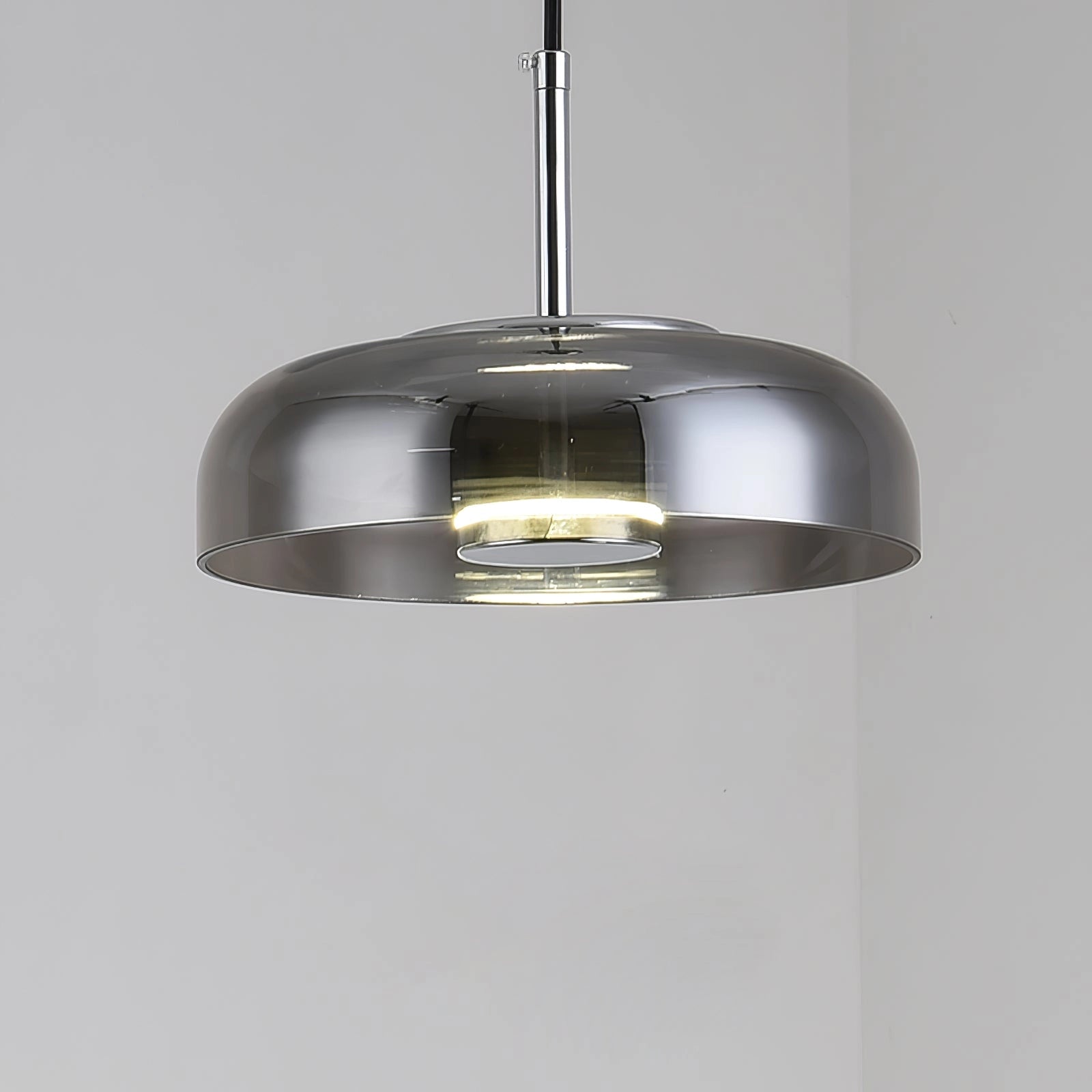 Modern Brass & Chrome LED Pendant Lights hanging from the ceiling, featuring a minimalist design with circular metal and glass elements.