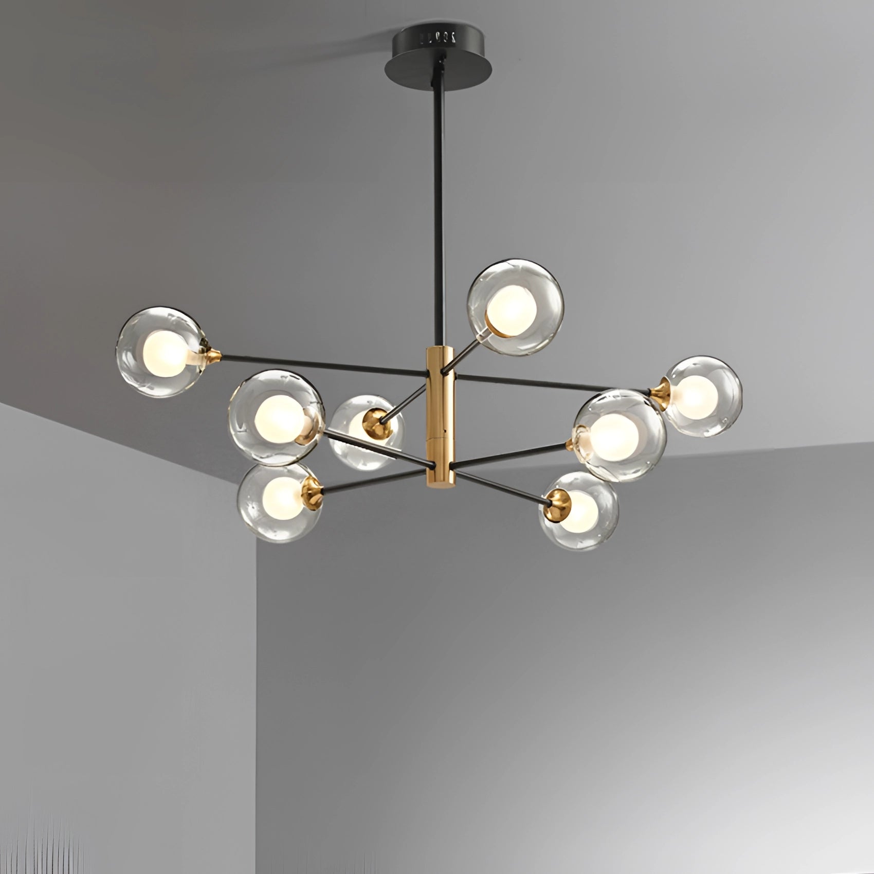 Modern Brass Geometric LED Chandelier with Mid-Century Minimalist Design featuring multiple circular metal rings suspended from the ceiling, emitting warm light.