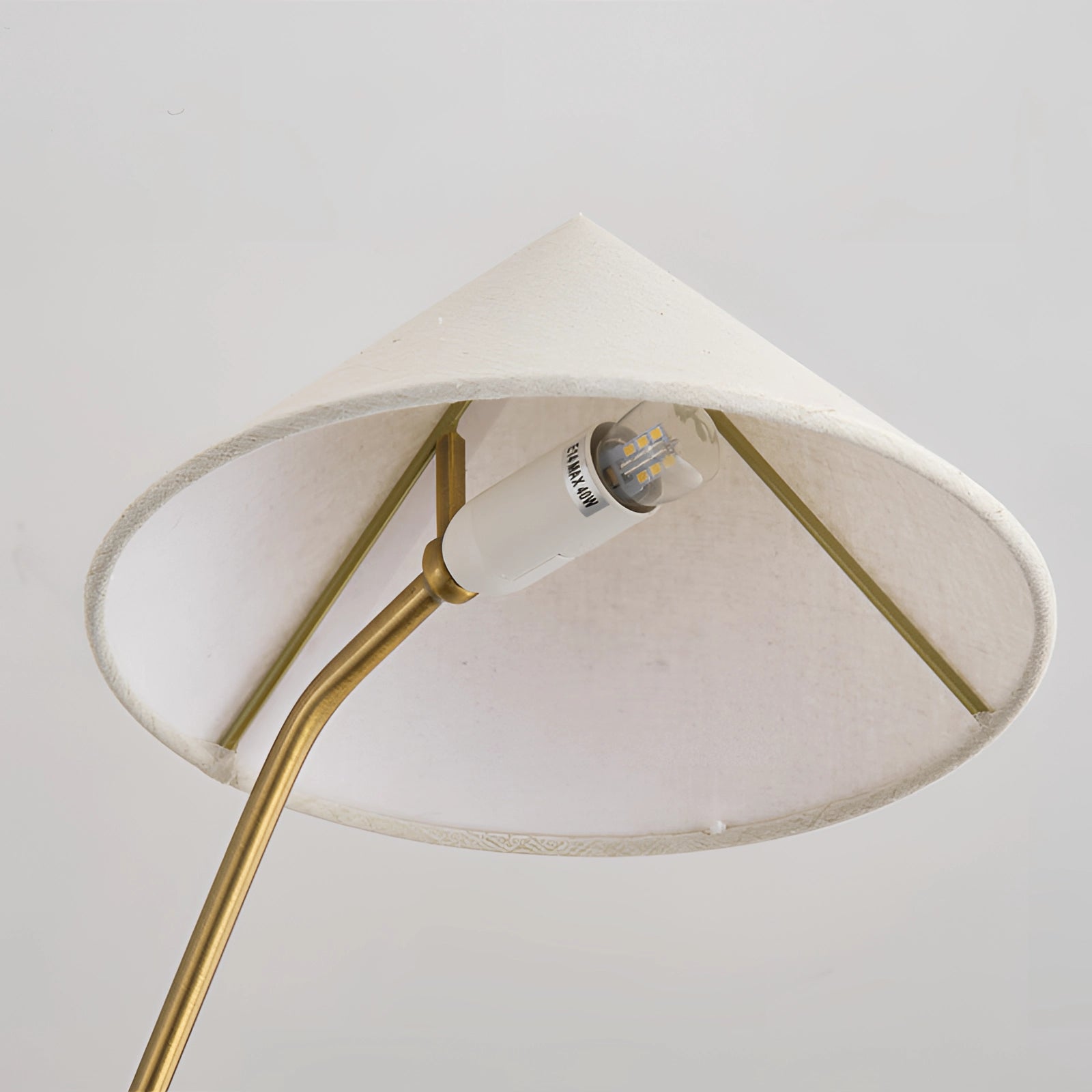 Modern brass geometric pendant chandelier with a mid-century minimalist design, featuring a stylish brass frame and beige shades, hanging from the ceiling.