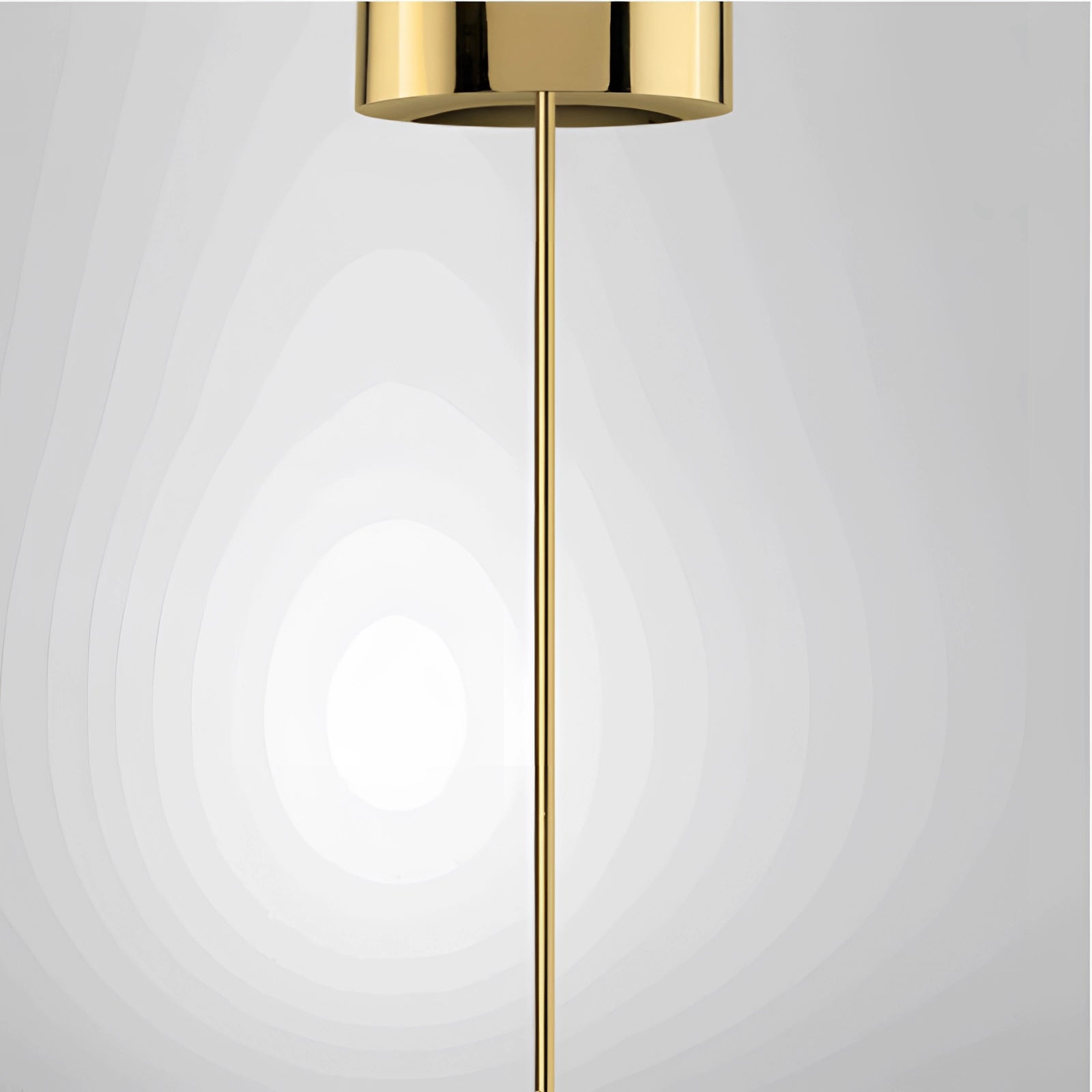 Modern brass globe pendant light hanging from the ceiling, featuring a minimalist design ideal for luxury kitchen decor, with warm amber tones and a sleek finish.