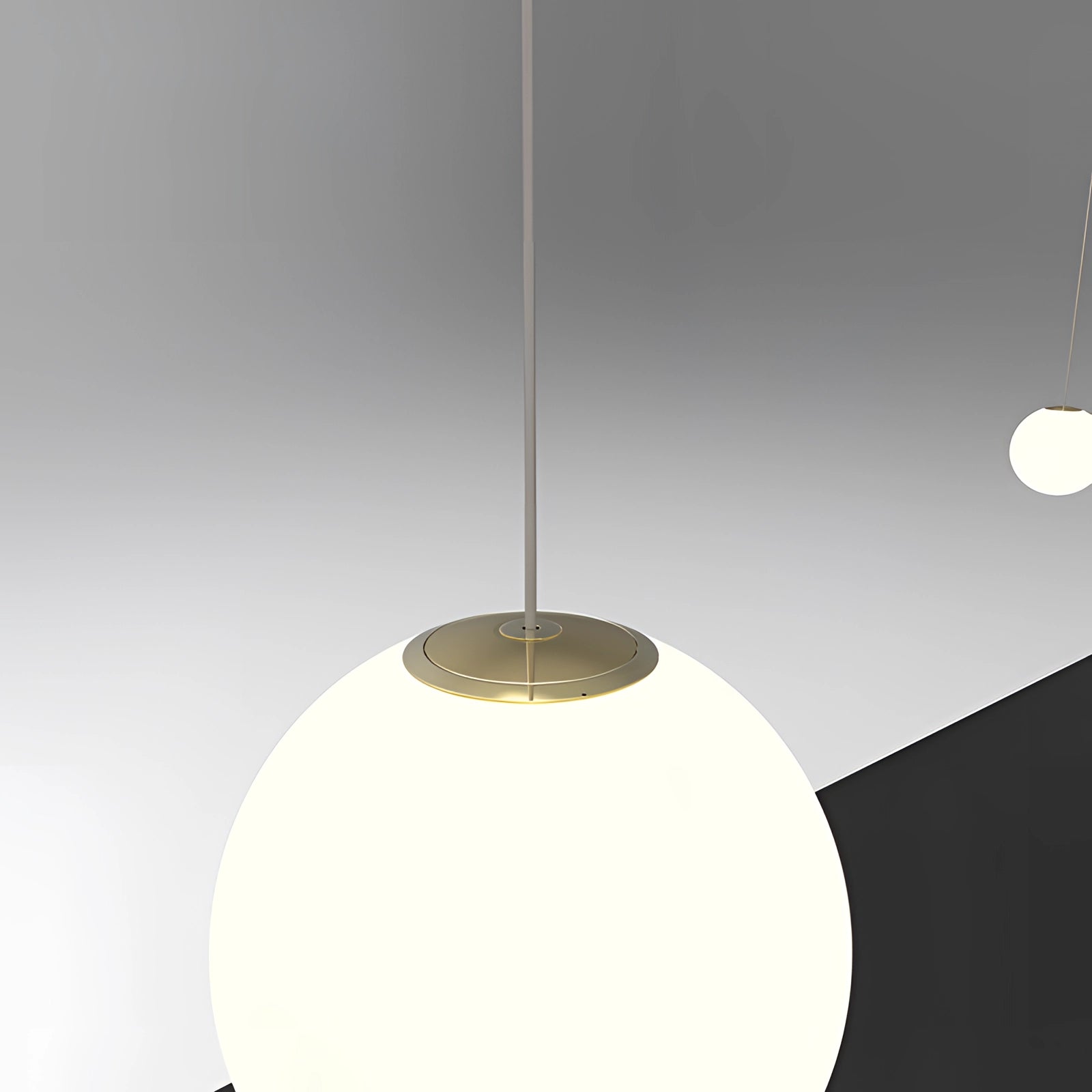 Modern brass globe pendant light with a minimalist design, featuring a smooth, spherical shape and suspended from the ceiling, casting a warm glow ideal for luxury kitchen decor.