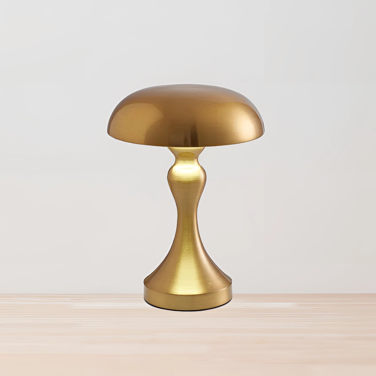 Elegant gold modern brass mushroom table lamp with a circular beige lampshade, featuring a stylish and artistic design.