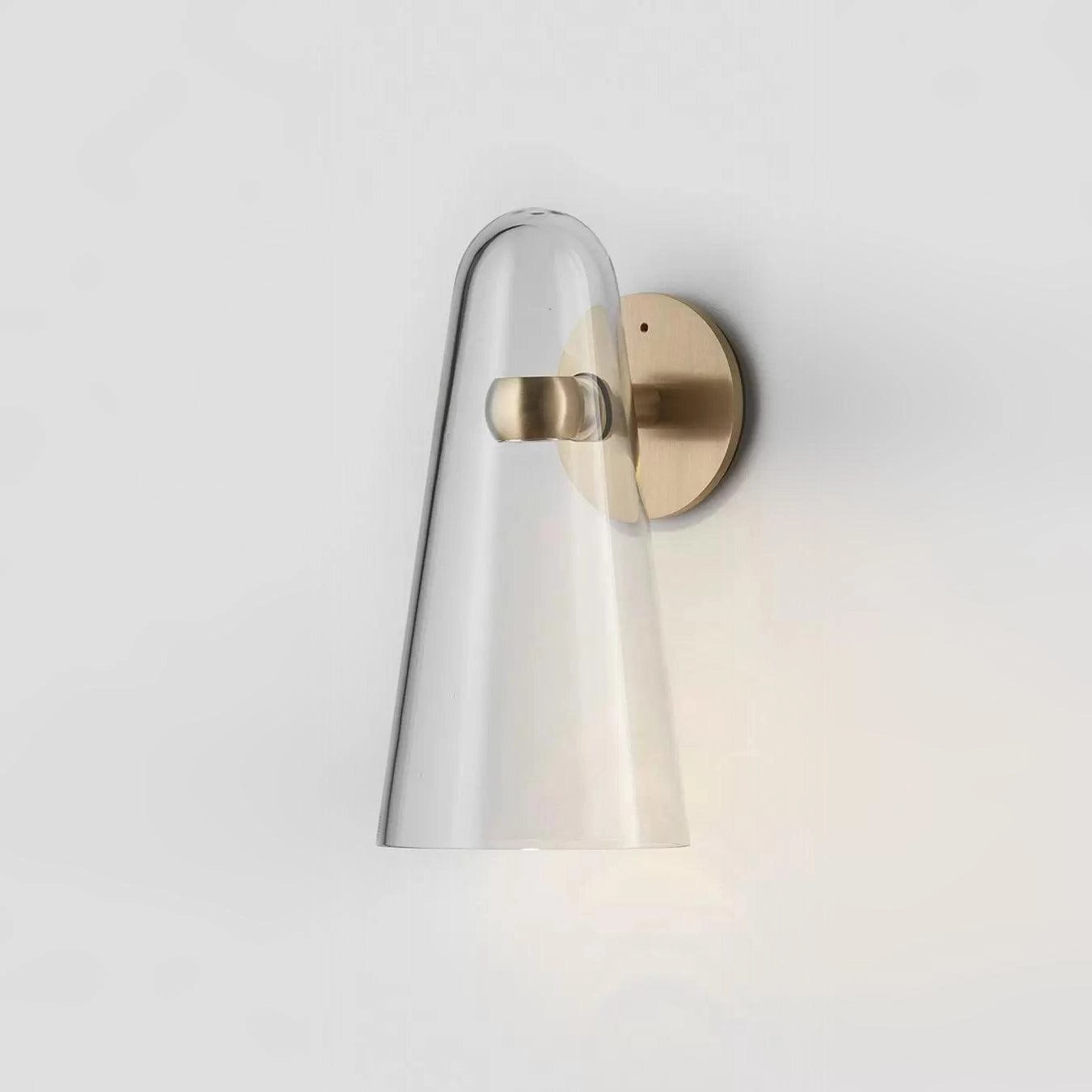 Modern brass outdoor wall sconce with a weather-resistant cylindrical design, featuring a sleek metal finish and transparency elements, suitable for exterior lighting.