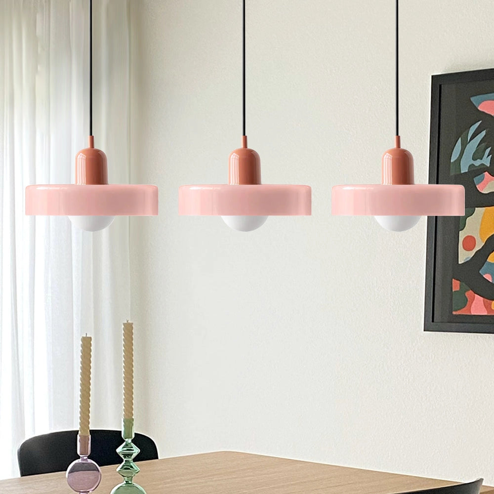 Modern brass pendant lights with three adjustable heads, featuring red cables and a Rosa+Pink finish, ideal for industrial kitchens.