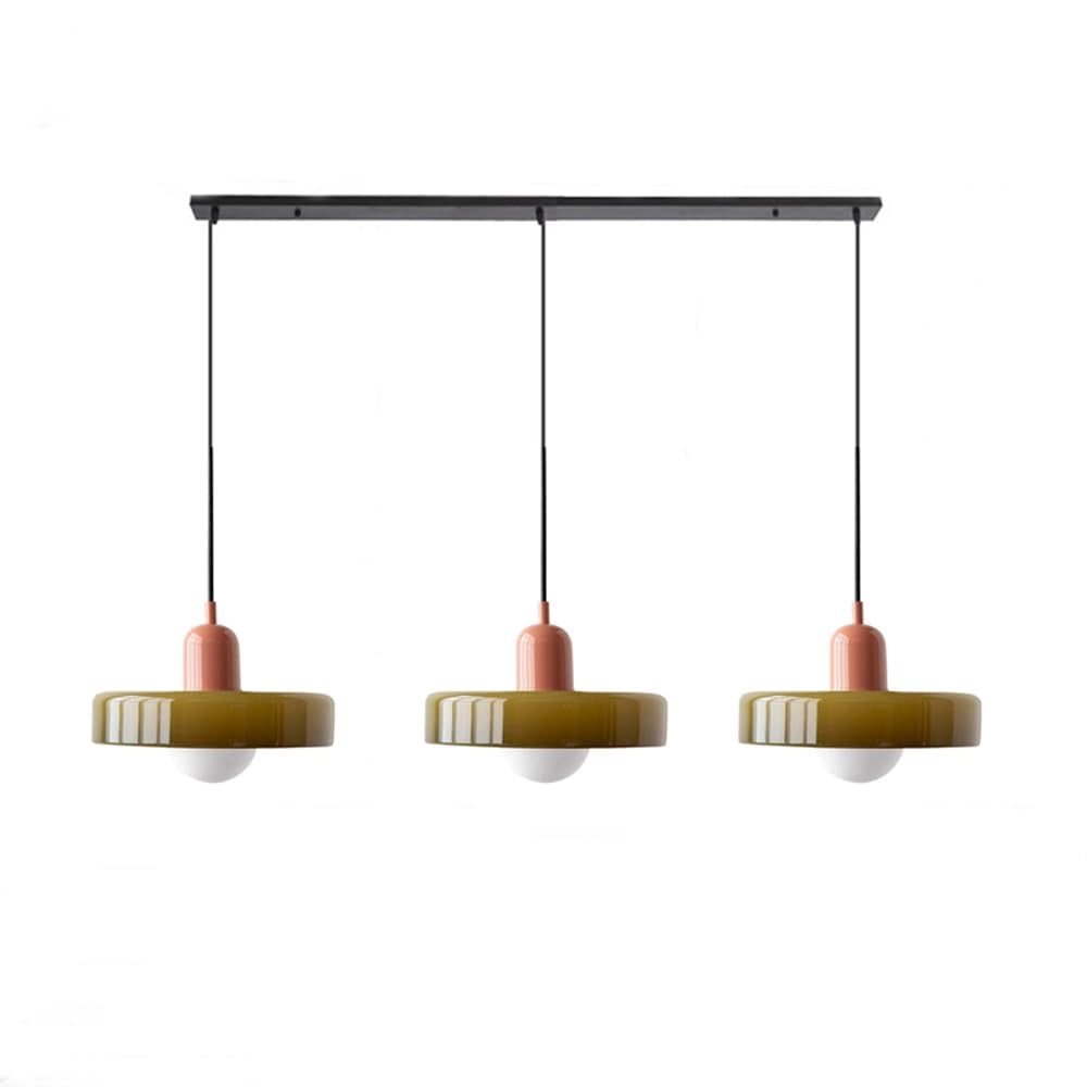Modern brass pendant light with an adjustable red cable, hanging from the ceiling, showcasing a sleek industrial design suitable for kitchens.