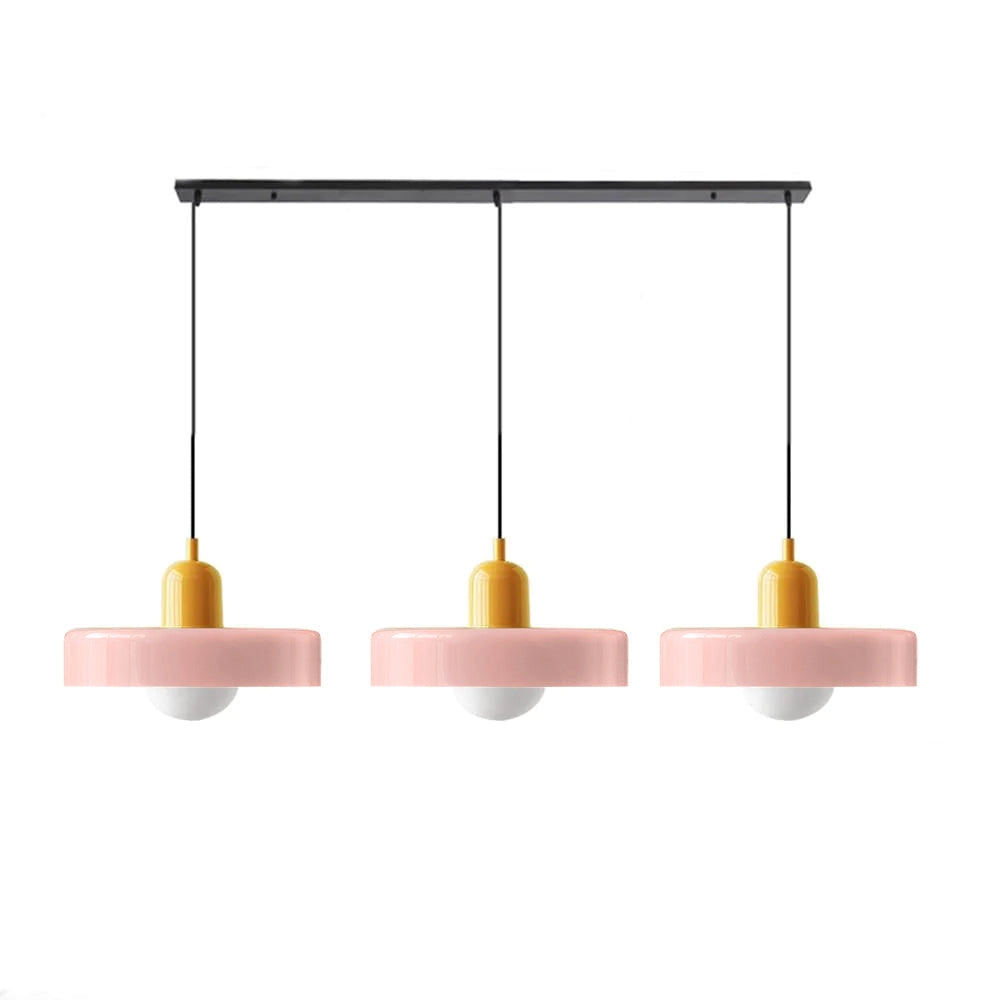 Modern Brass Pendant Light with Red Cable, Hanging in an Industrial Kitchen with Shelving and Candle Holders