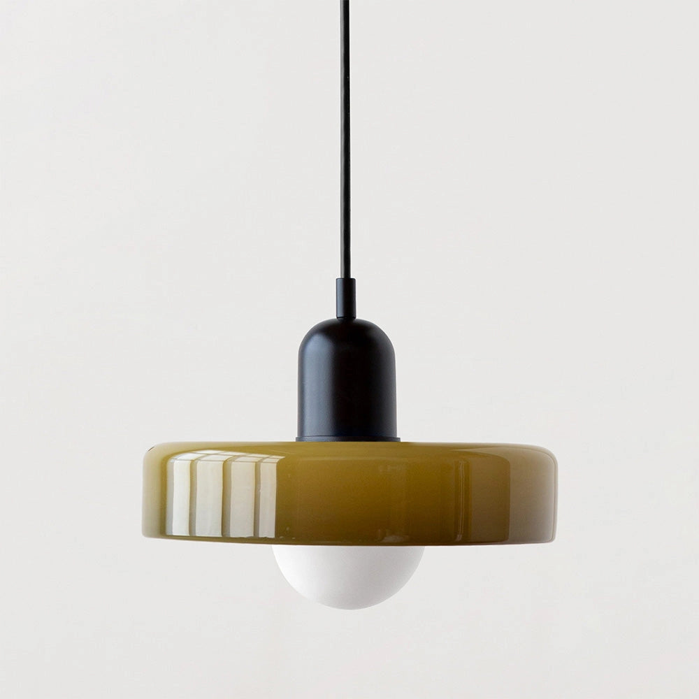 Modern brass pendant light hanging from the ceiling with an adjustable red cable, featuring a sleek metal design suitable for industrial kitchens.