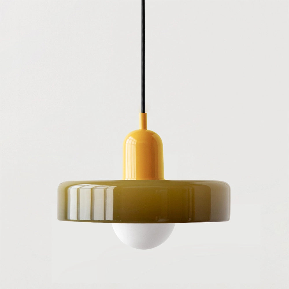 Modern brass pendant light with an adjustable red cable, hanging from a wooden ceiling, featuring a sleek cylindrical design, ideal for industrial kitchens.