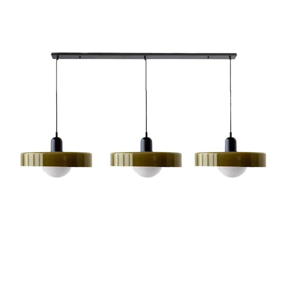 Modern brass pendant lights with a red cable, hanging from a ceiling, illuminating an industrial kitchen with shelving units and wooden accents.