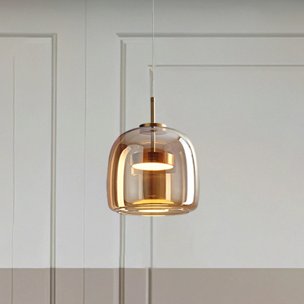 Modern brushed brass glass pendant light with a sleek, rectangular design, hanging from a ceiling fixture, suitable for illuminating kitchens and dining areas.