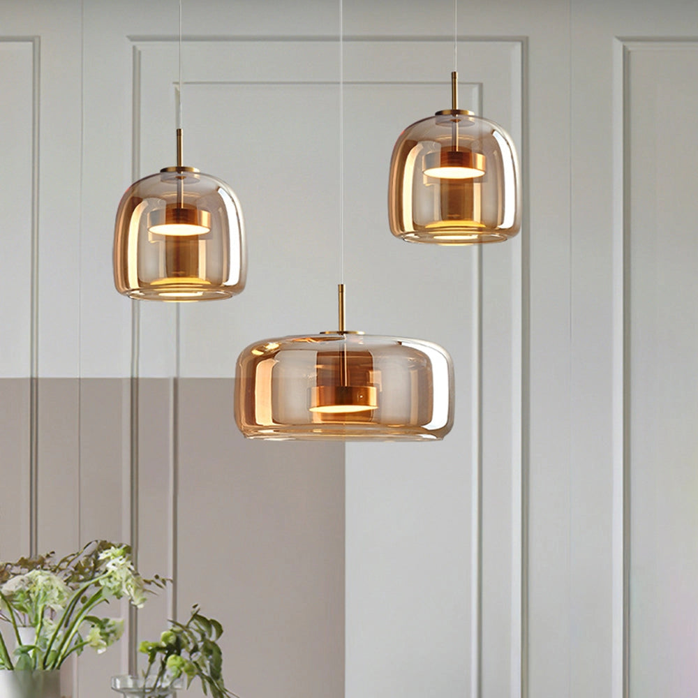 Modern brushed brass glass pendant light fixture with a rectangular design, featuring gold and wood elements, suitable for kitchens and dining areas.