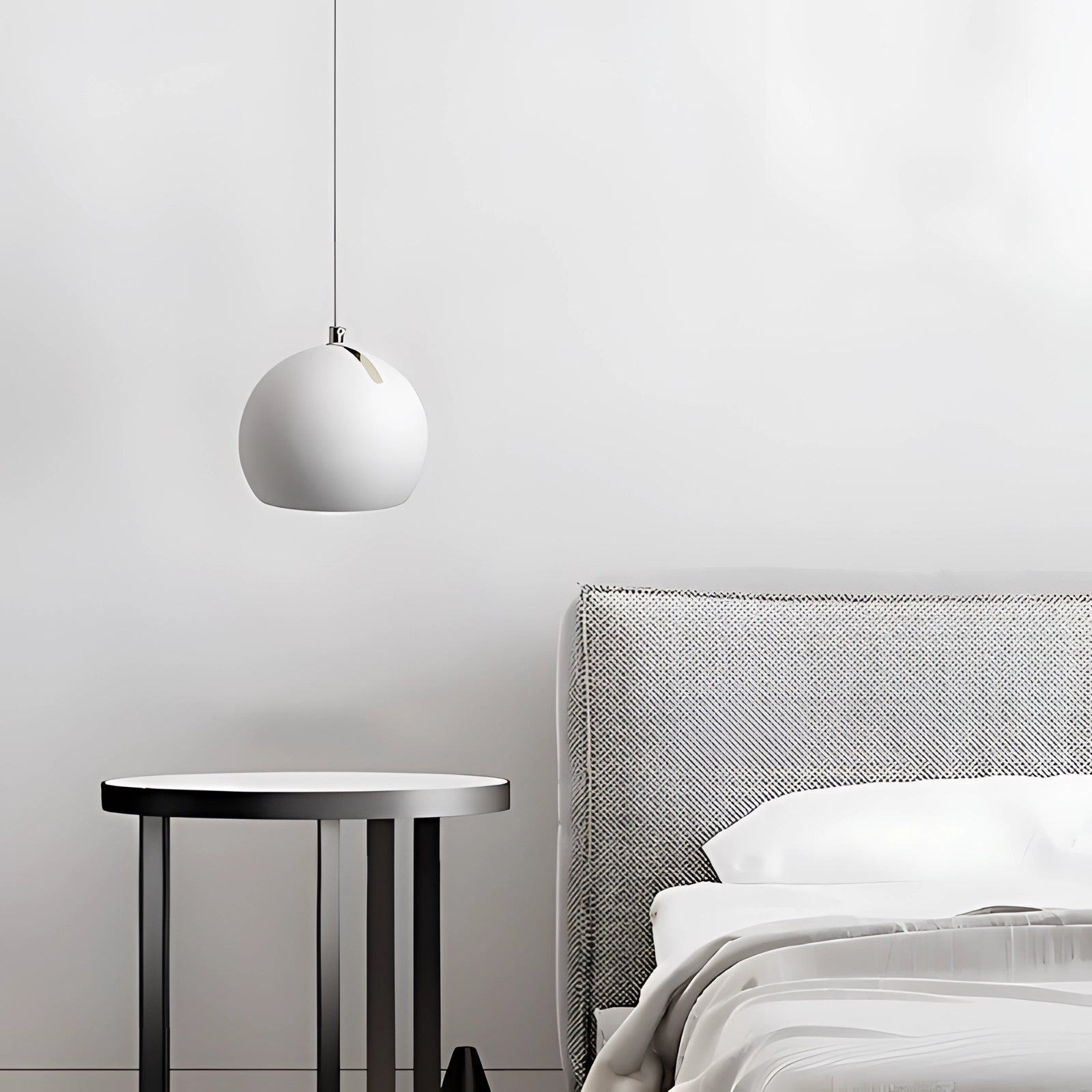 Modern ceramic globe pendant lights in a luxury white finish, hanging over a stylish interior space with grey and wood elements, including a rectangular table and comfortable furnishings.