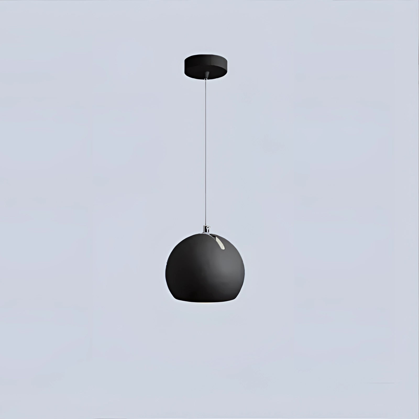 Modern ceramic globe pendant light in black with a warm white glow, featuring a spherical design and suspended as a sleek ceiling fixture.