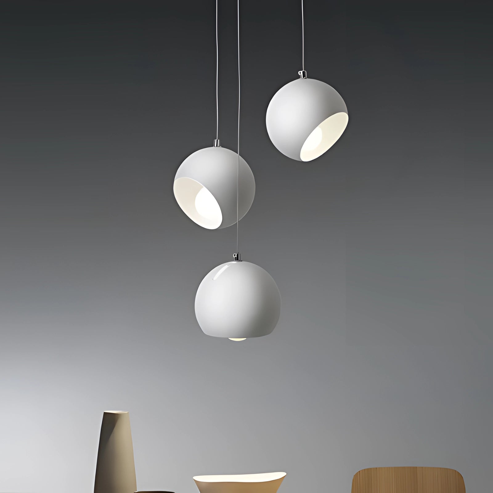 Modern ceramic globe pendant lights in white, showcasing adjustable luxury design with soft illumination.
