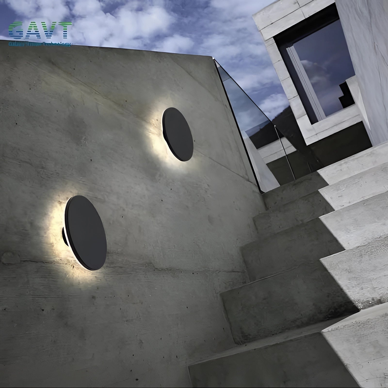 Modern circular LED wall lights illuminating a contemporary outdoor stairway with a sleek and minimalist design against a cloudy sky background.